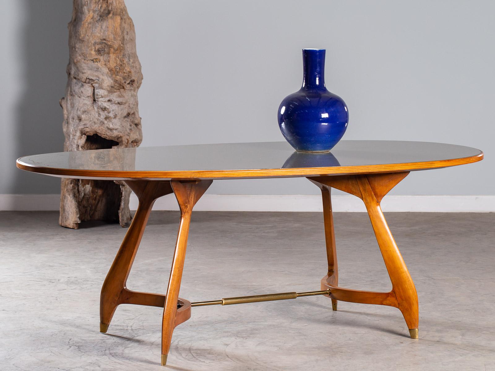 A truly one of a kind vintage Italian oval maple table attributed to Ico Parisi or Gio Ponti, circa 1950 having a celadon green reverse painted glass top. Please enlarge the photographs to see the unique details that give this table its connection