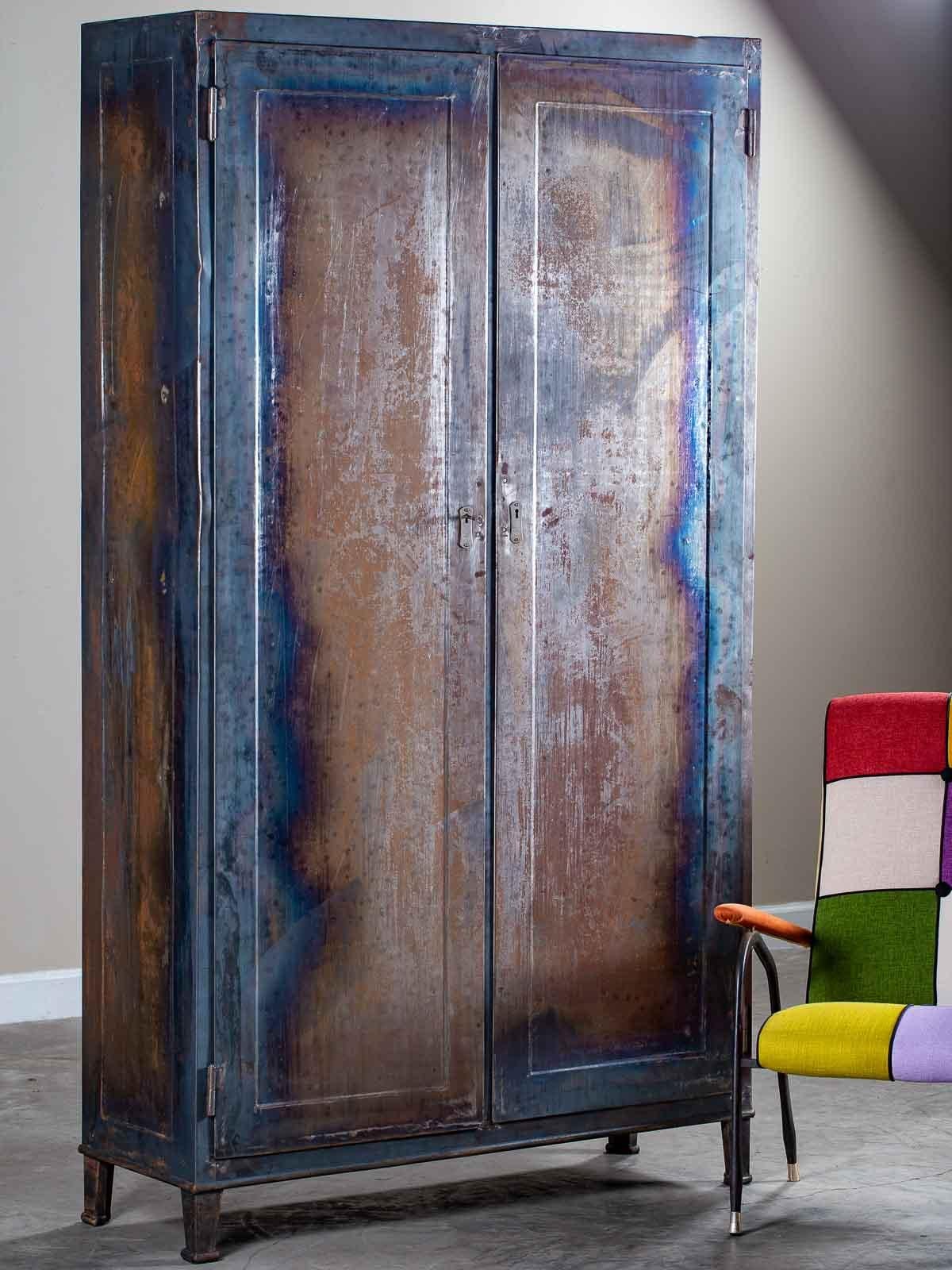 This tall and shallow vintage modern Italian industrial armoire storage cabinet, circa 1940 features the original oxidized finish. Notable for its simple contemporary profile this all metal cabinet has two long doors opened by a key to reveal