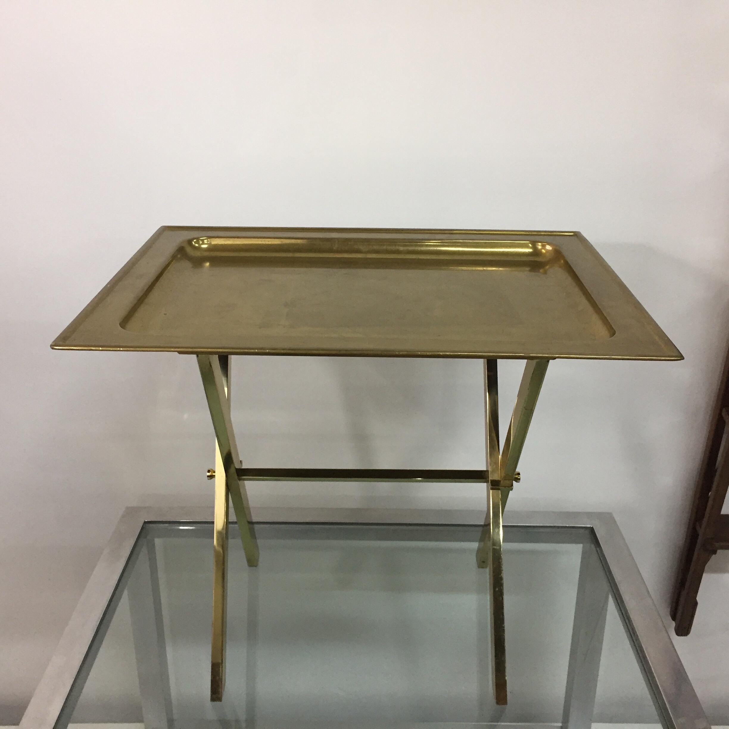 This all brass tray table and folding base in the style of Jansen from the 1970s was found in Italy. Great entertaining table or as a side table, easy to store if not needed. This item shows the appropriate age and patina from years of loving use.
