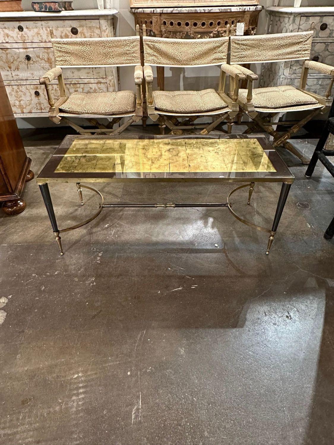 Vintage Italian Jansen style brass and gold foil glass top coffee table. A favorite of top designers!.