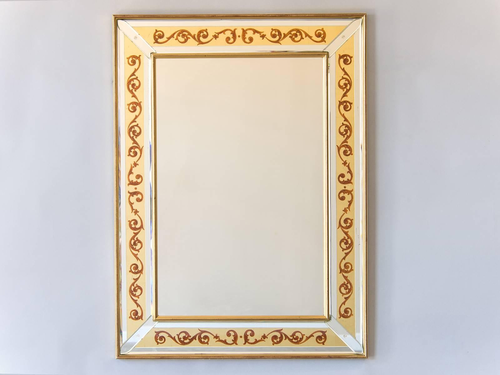 The bold form of the scroll contained within the borders of this vintage Italian mirror, circa 1950, is actually painted on the reverse side of the mirror glass using a technique known as 