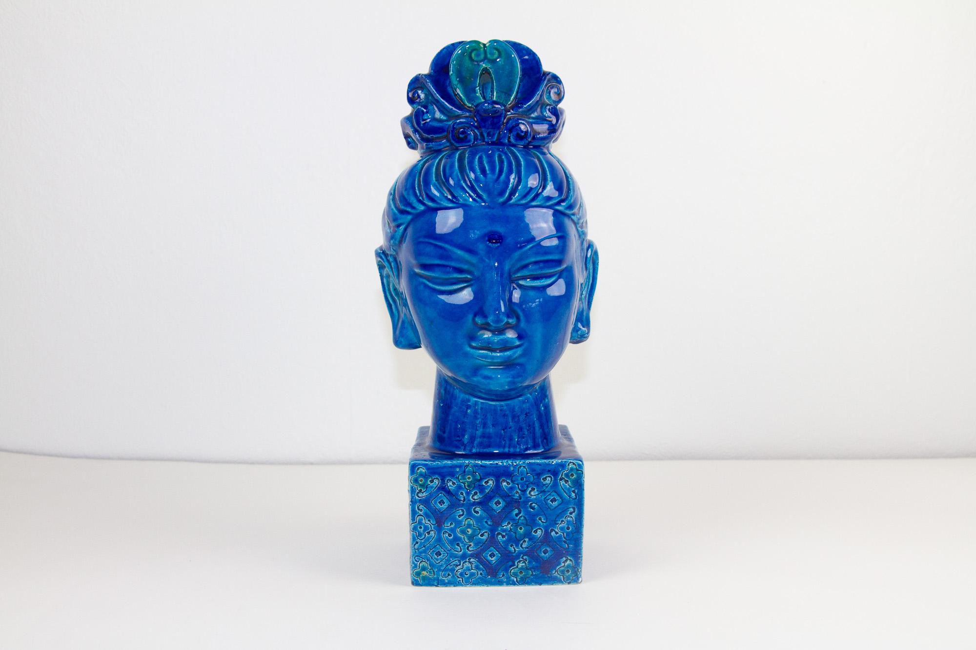 Vintage Italian Kwan Yin Figurine byt Aldo Londi for Bitossi, 1960s
Aldo Londi for Bitossi Buddha head on plinth in blue glaze ceramic with hints of green. This female Buddha Kwan Yin / Gua Nyin sculpture from the 1960s was often bought to bring
