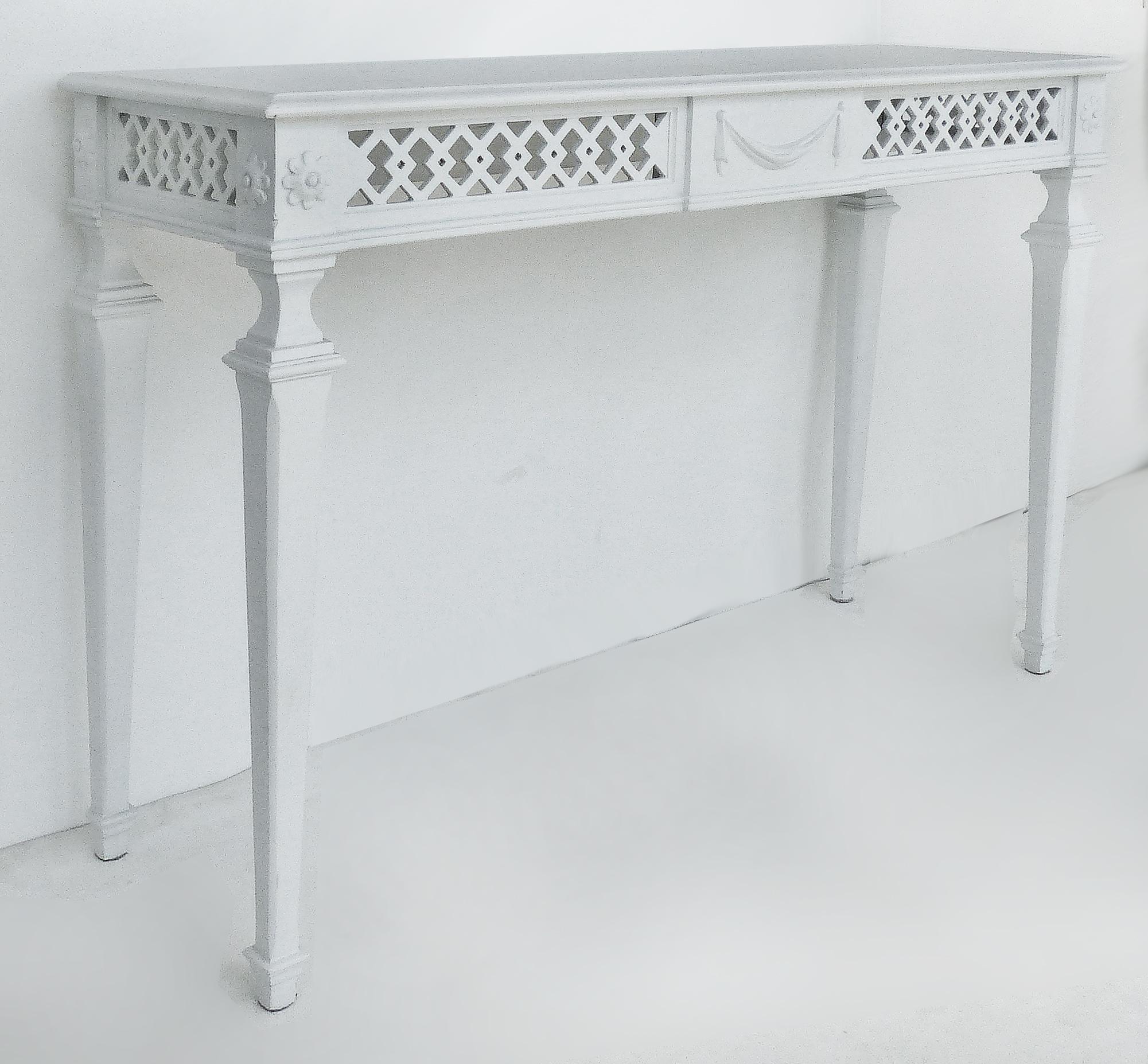 Vintage Italian lacquered carved consoles tables with carved reticulated aprons.


Offered for sale is a pair of vintage Italian white lacquered console tables with reticulated open aprons. The consoles have recently been lacquered. At the