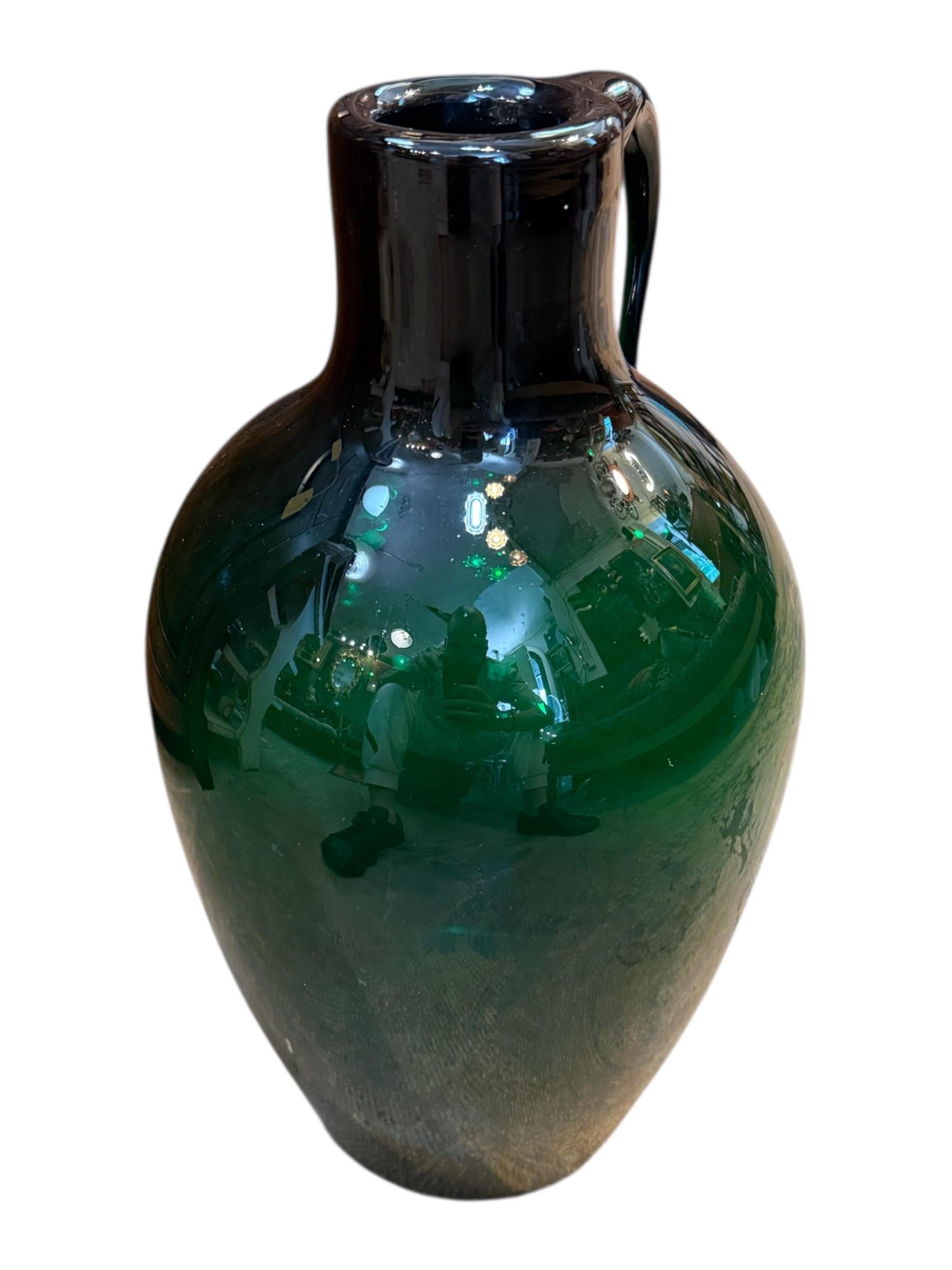 Elevate your space with this Vintage Italian Green Ewer Vase, a stunning example of Mediterranean artistry and old-world charm. Handcrafted in Italy, this large ewer-style vessel features a beautifully exaggerated spout and curvaceous handle, all