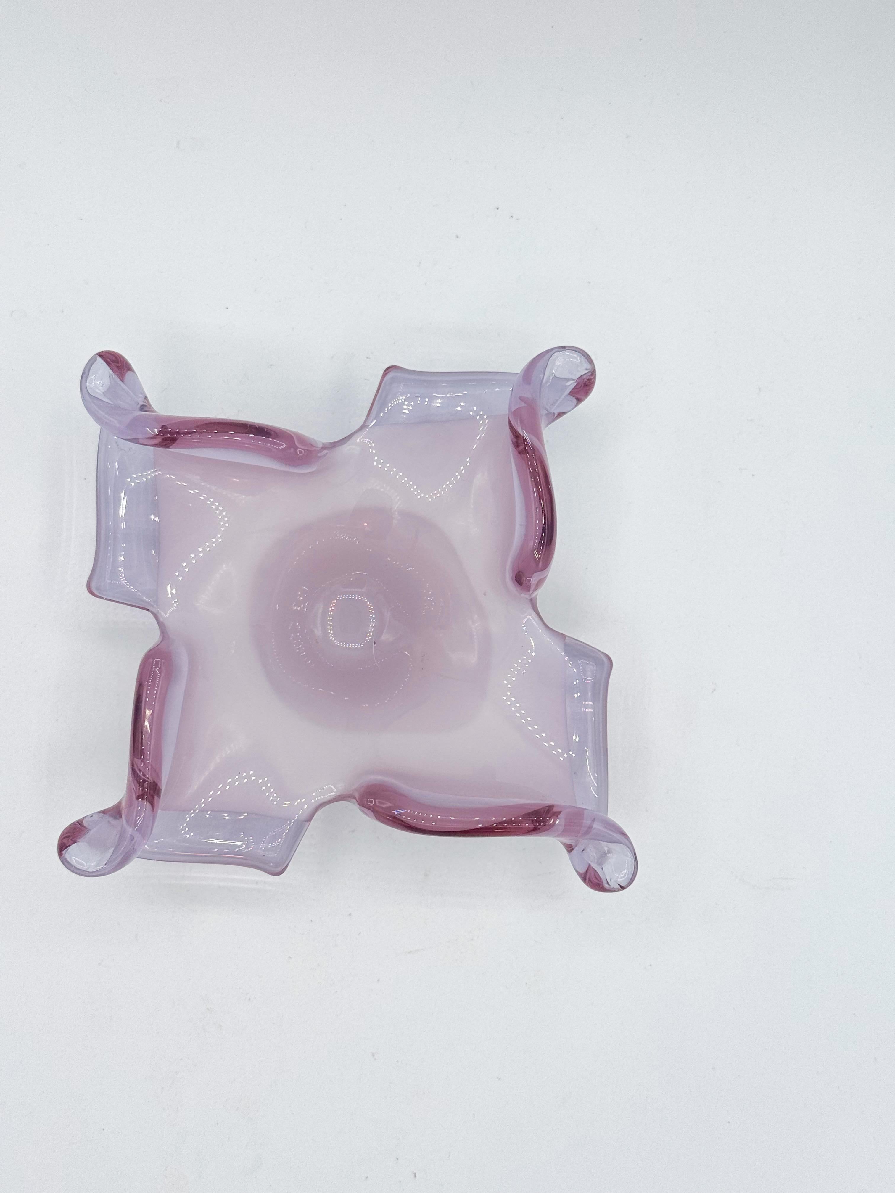 This exquisite lavender art glass dish was handblown in Italy by V.A.N. Crystal during the mid-20th century, a period celebrated for its innovation in Murano-inspired glass design. The piece showcases a soft purple-lavender tone with delicate