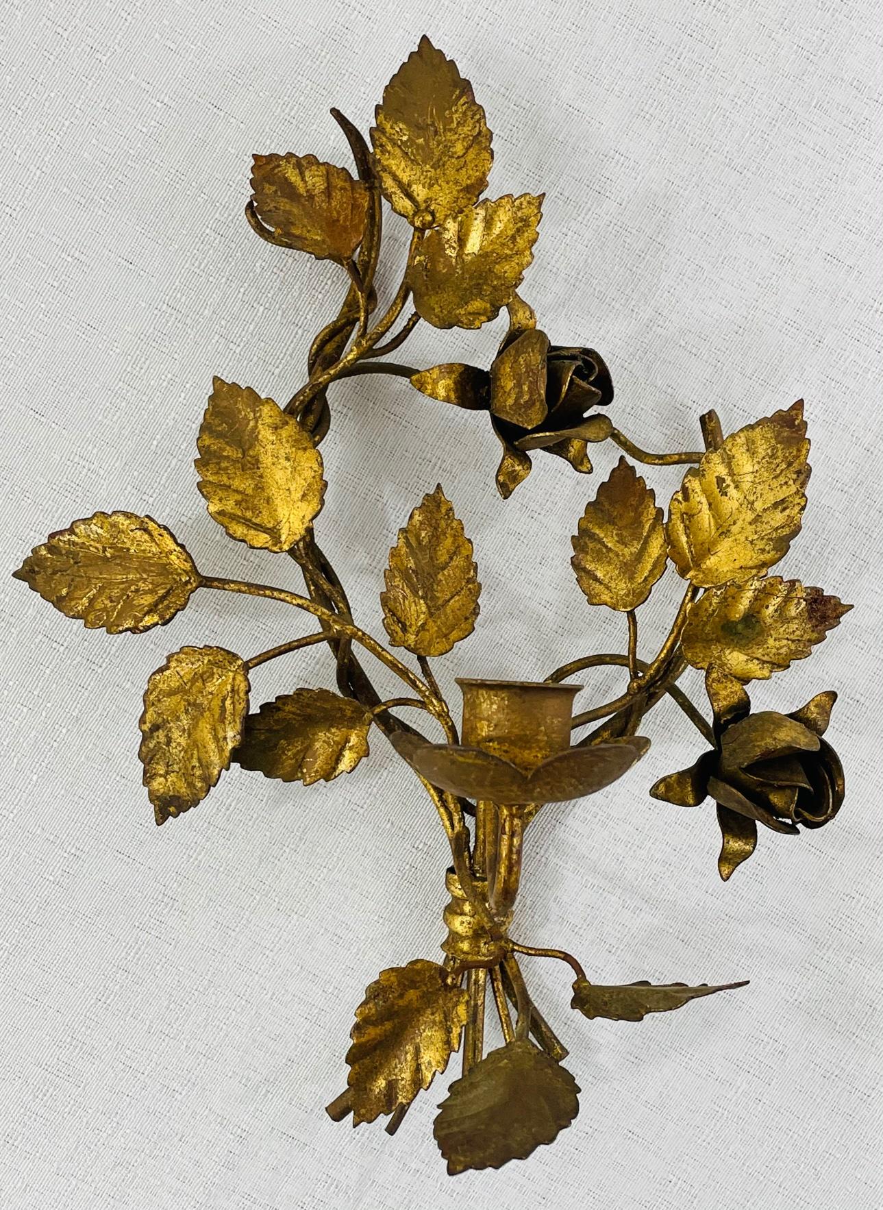 A 1960's pair of Italian gilt gold tole metal candle wall sconces. Each sconce features delicate leaf design and holds one candle. The wall sconces are not wired. 

Dimensions: 10