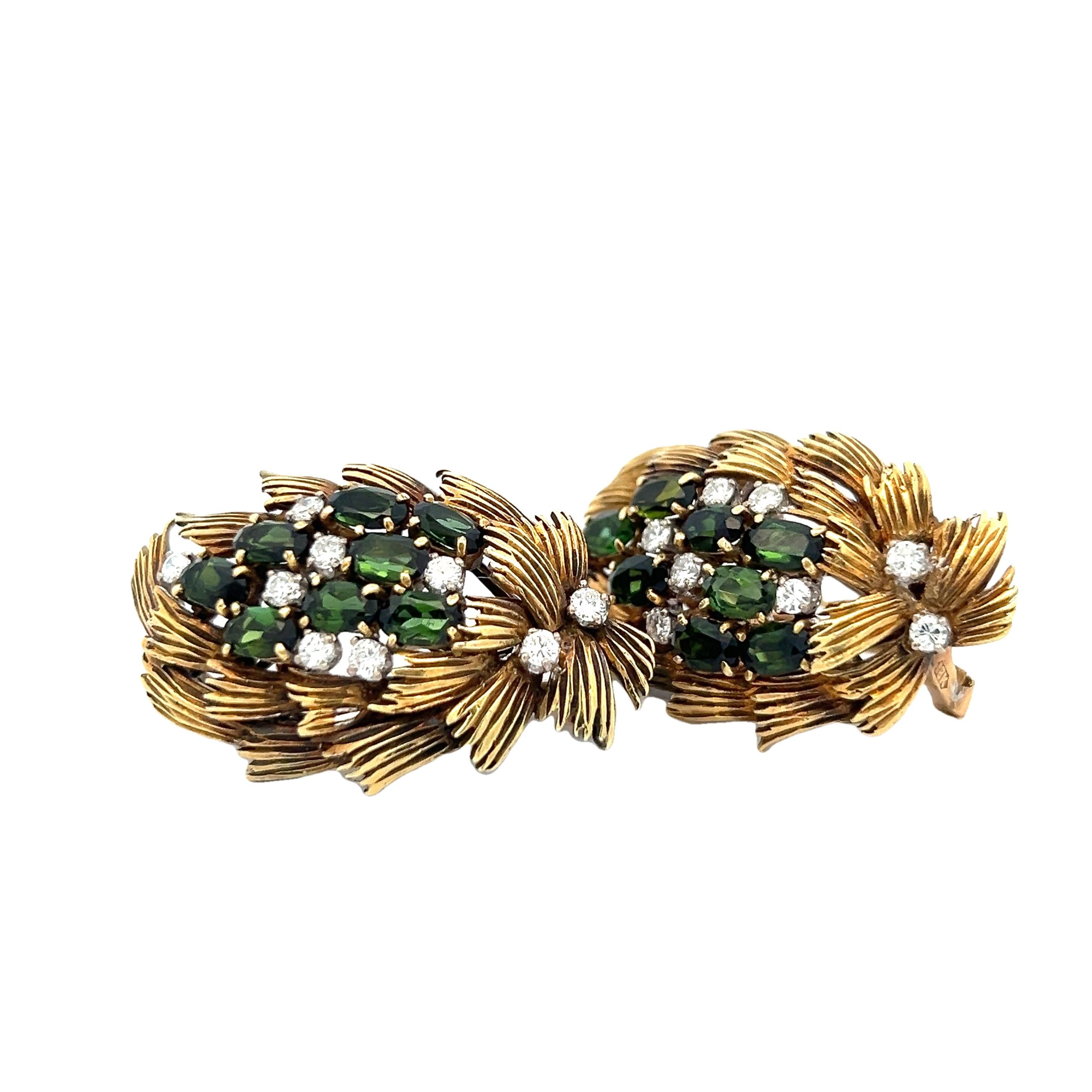 These exquisite vintage Italian earrings showcase a richly textured leaf motif design, crafted in 18K yellow gold with remarkable sculptural detail. Each earring is set with a vibrant cluster of deep green tourmalines—14 stones totaling