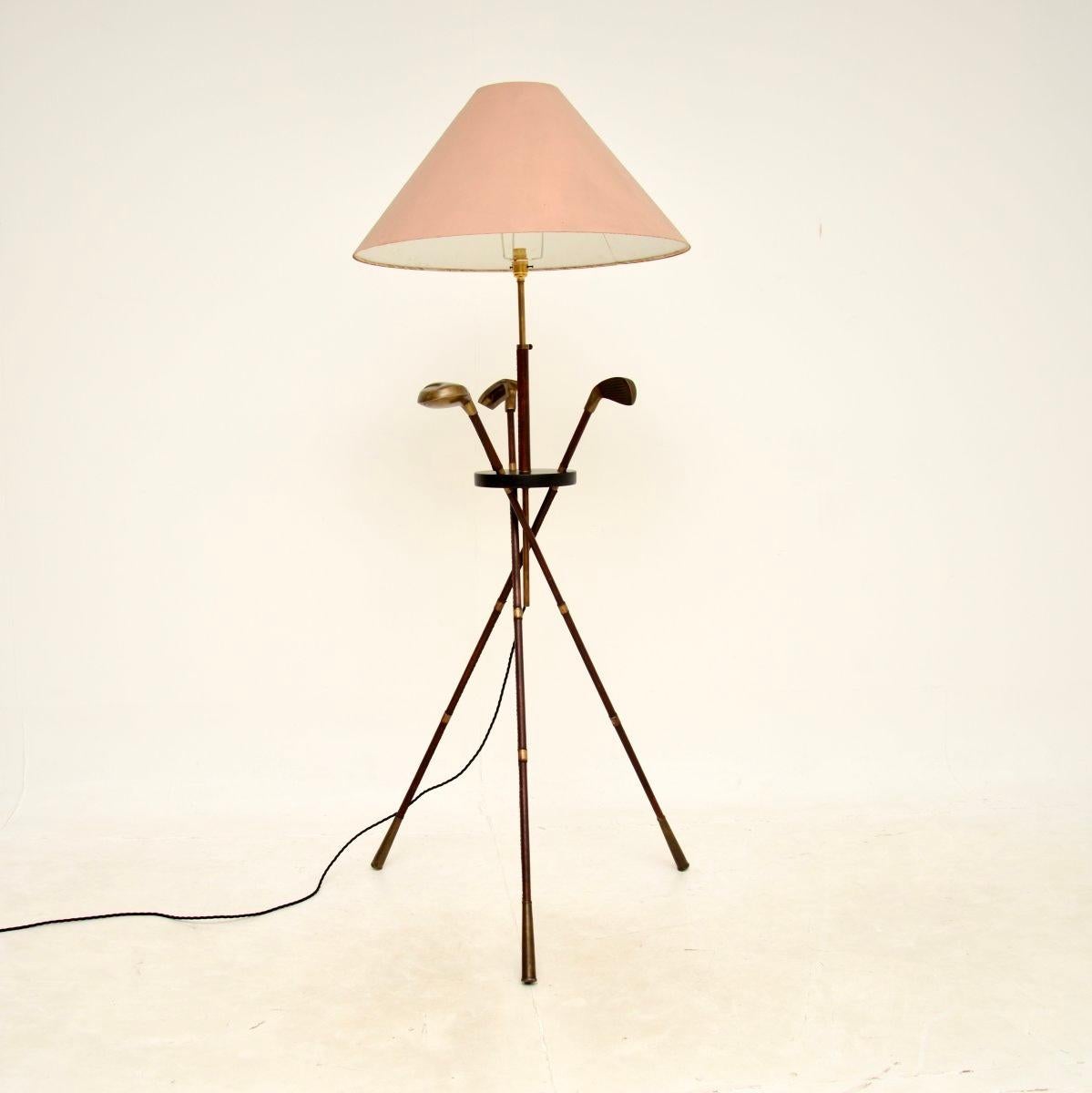 A very interesting and stylish vintage Italian leather and brass floor lamp. This was made in Italy, it dates from around the 1970’s.

It is designed as three golf clubs leaning on each other, the shafts all clad in leather with brass handles and