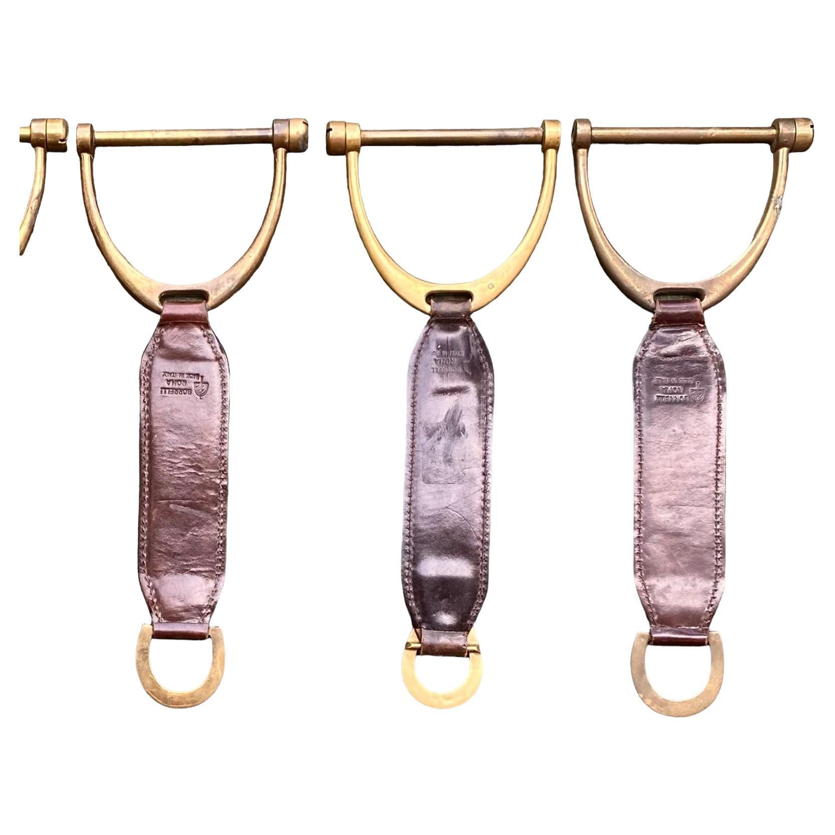 A stunning set a five vintage Italian hand stitched, fine leather and solid brass stirrups, Borrella Roma, made in Italy stamped in the leather. 

These are works of art suitable to hang on your wall as any other fine art.