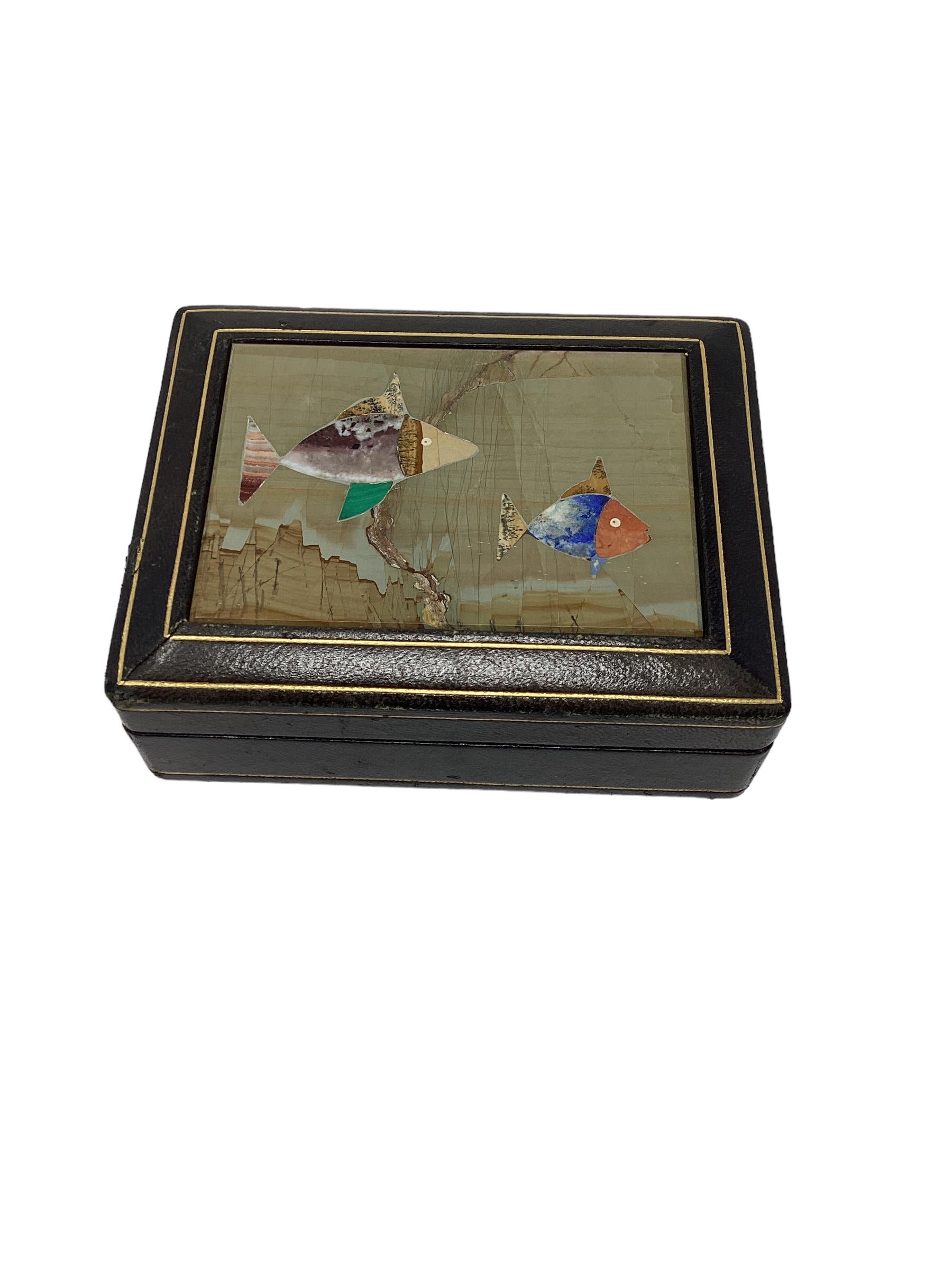 Vintage Italian leather box with pietra dura inset tile decorated with brightly colored fish. The interior is wood lined. This would have held trinkets or cigarettes. Stamped on the bottom “Made in Italy “