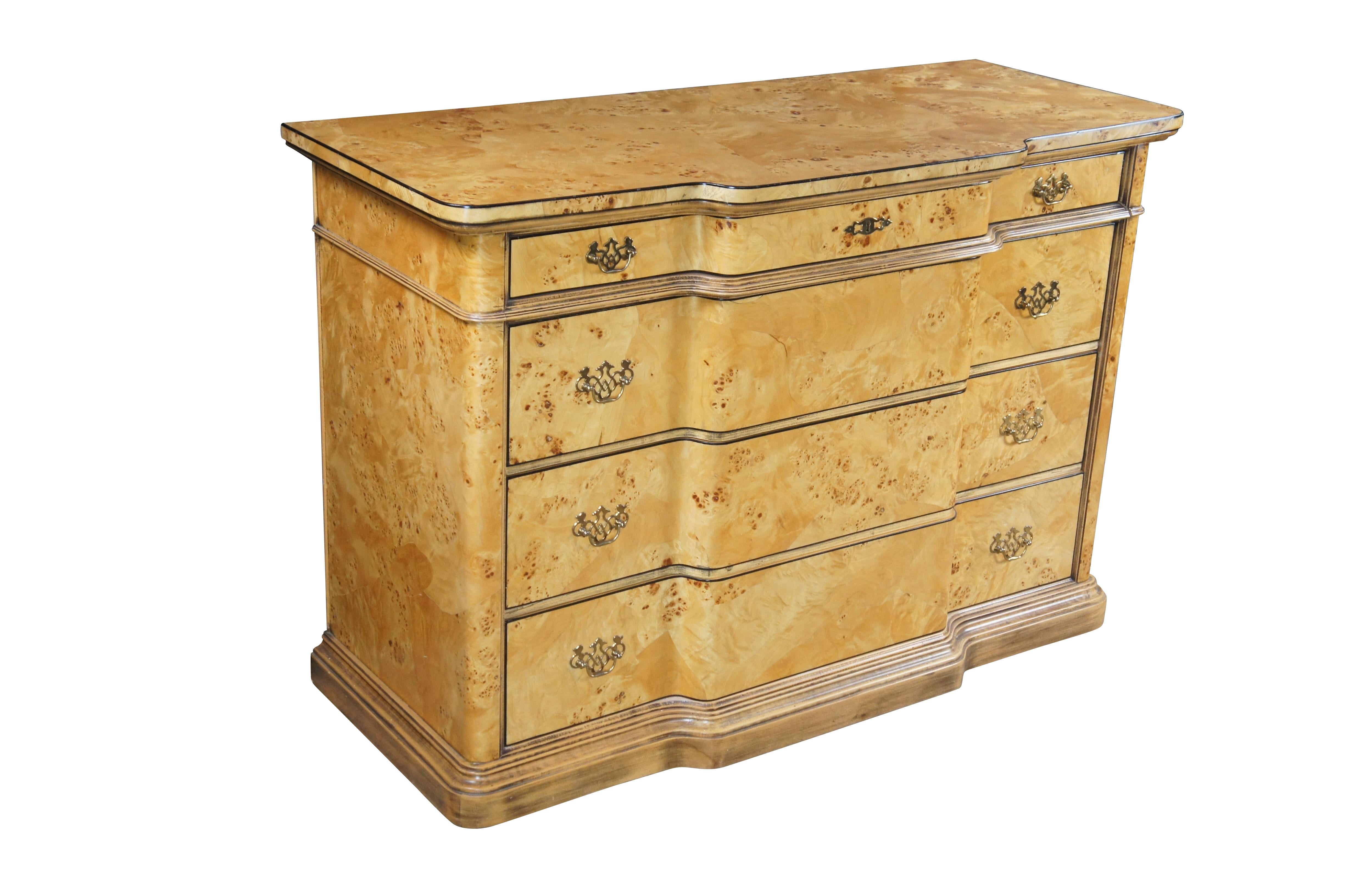 Late 20th Century Italian Commode, circa 1970.  Drawing inspiration from Louis XVI 
Biedermeier styling.   Features a breakfront form with birdseye maple veneer and classical interlaced brass bale pulls.  The chest showcases four drawers made