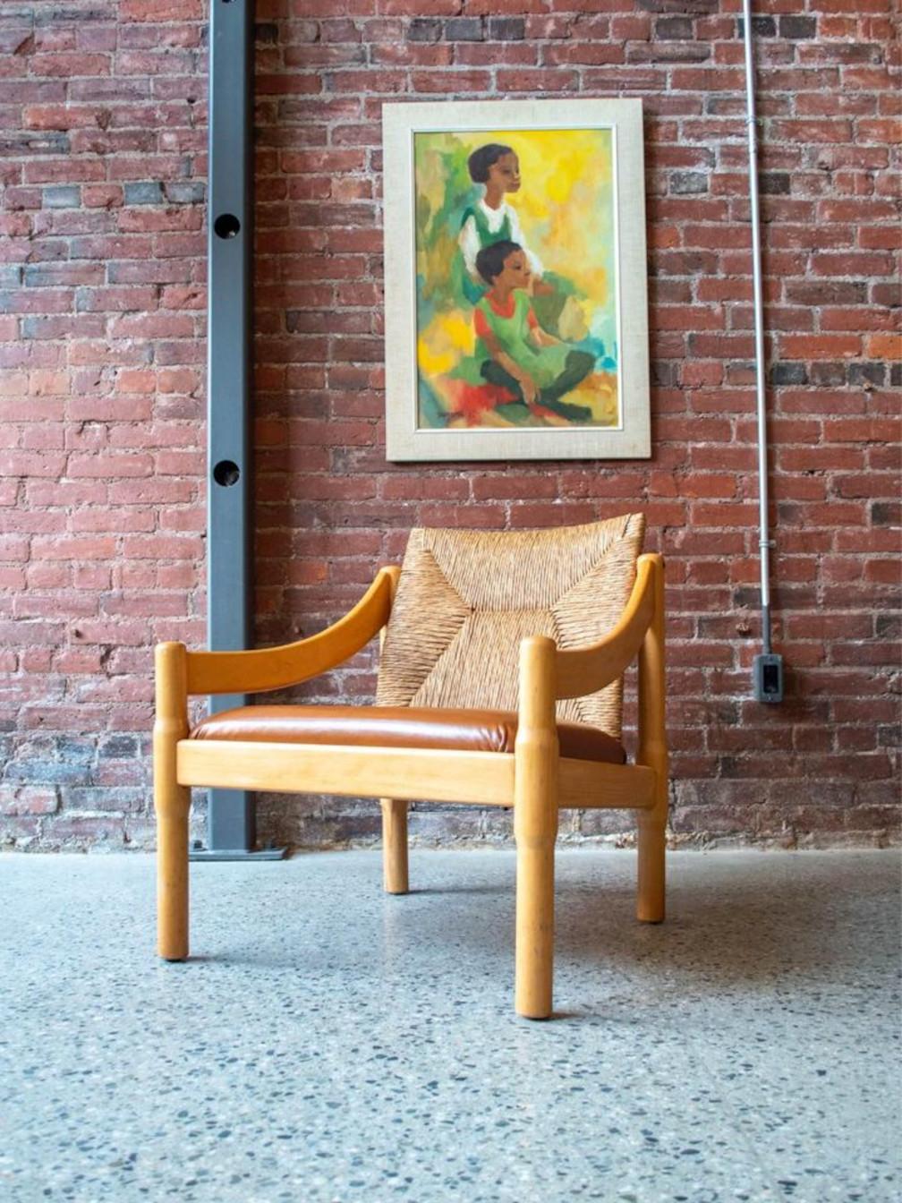 Fresh to our showroom is a distinctive lounge chair designed by Vico Magistretti. This unique piece showcases a robust beech frame, an intricately crafted rattan backrest, and a pristine new leather seat—a captivating blend of premium materials.