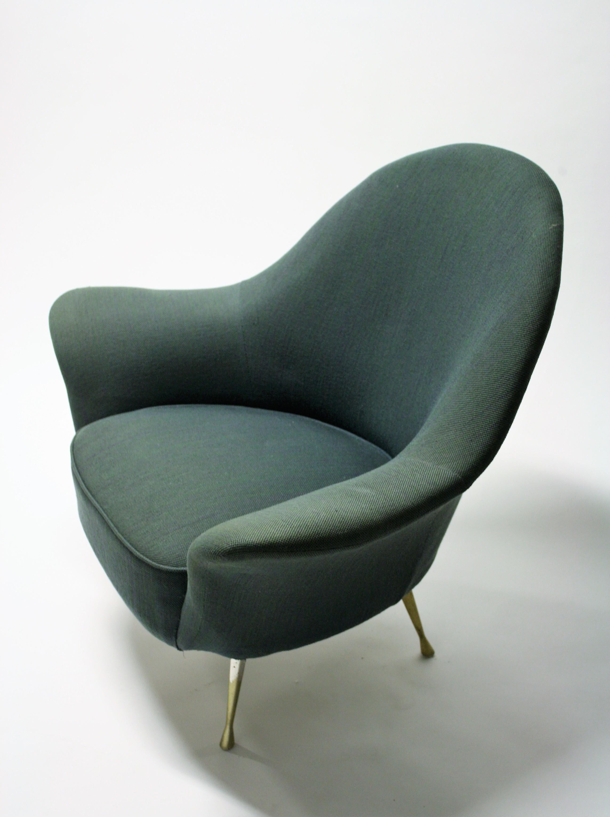 Elegant midcentury cocktail chair or club chair.

Although no designer is linked to this chair it has some good design features. 

The armrests are elegantly shaped and the brass feet are made in one piece and have a lovely design.

The chair
