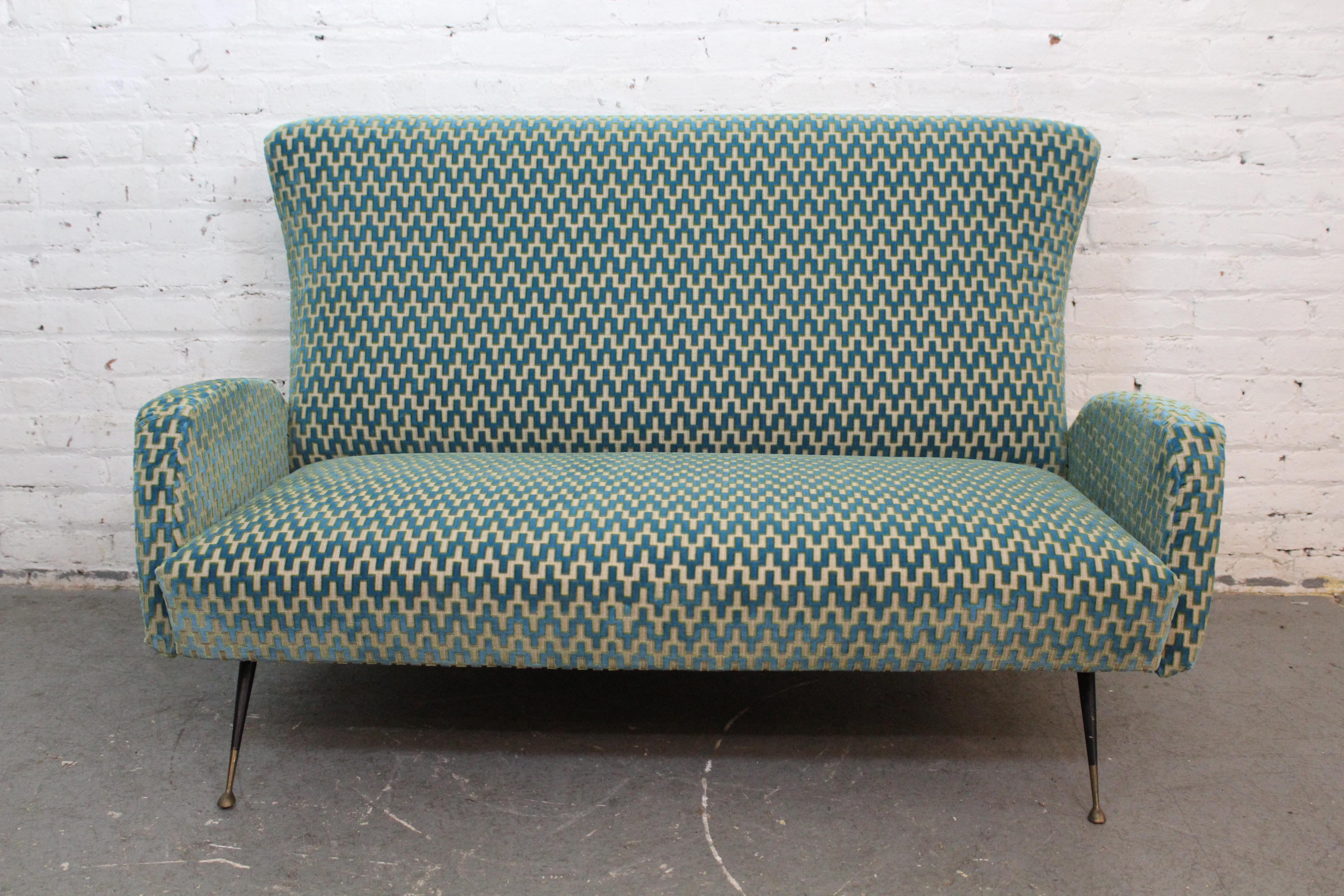 Add a beautiful touch of iconic 1950's Italian design into your home or casa with this truly mesmerizing vintage love seat. Built in the manner of legendary furniture makers from Industria Salotti e Arredamenti (better known as ISA Bergamo) this