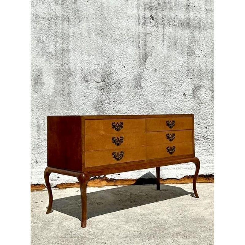 Discover unparalleled European elegance with this exquisite Vintage Italian Low Chest of Drawers, a testament to sophisticated design and masterful craftsmanship. Crafted with a lustrous, highly figured burl wood veneer that radiates warmth and
