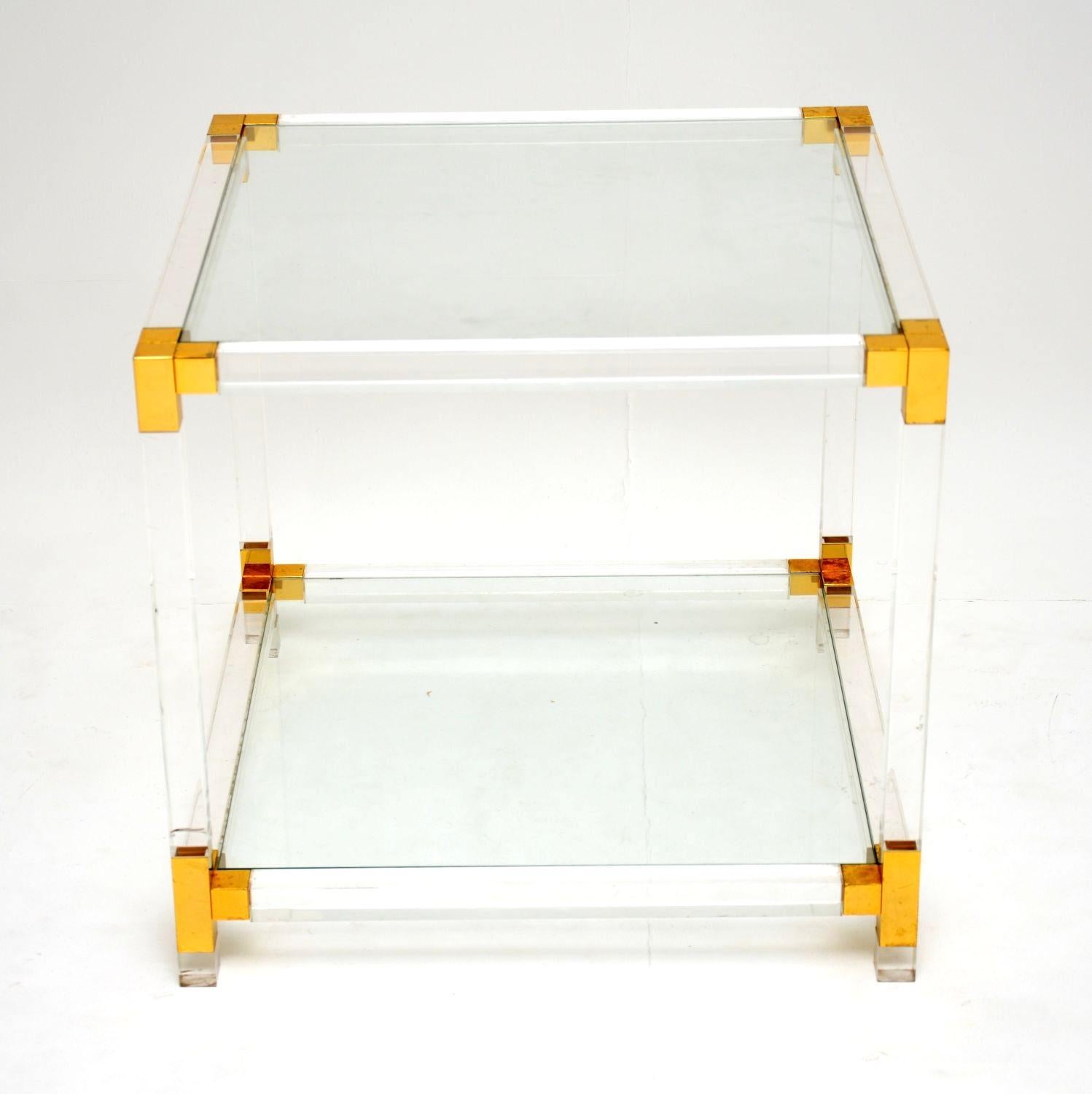 A stylish and very well made vintage Italian Lucite and glass coffee / side table. This was made in Italy, it dates from the 1970’s.

It has a thick, clear acrylic frame with brass plated trim, and two glass tiers.

The condition is very good for