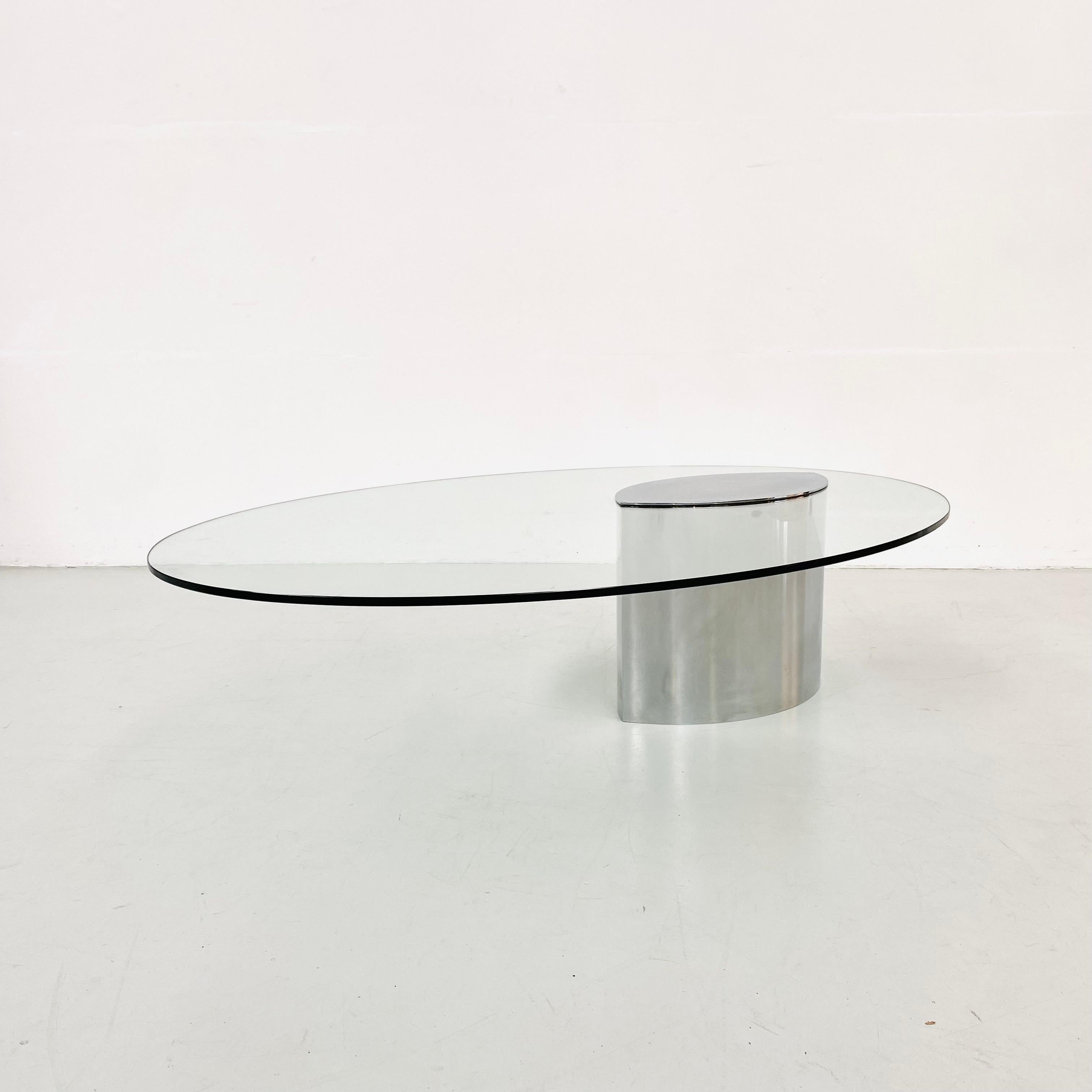 This mid-century oval glass and steel coffee table was designed by Maria Cristina Mariani 