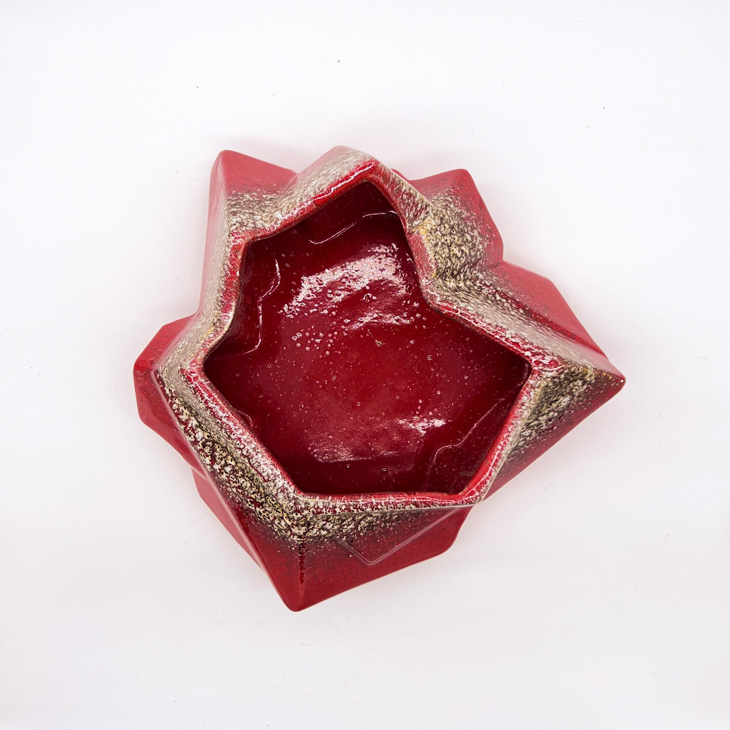Vintage red ceramic bowl - valet tray, made in Italy in the 1970s with an abstract geometric shape. Hand painted, with a deep red base layer and a series of decorative 