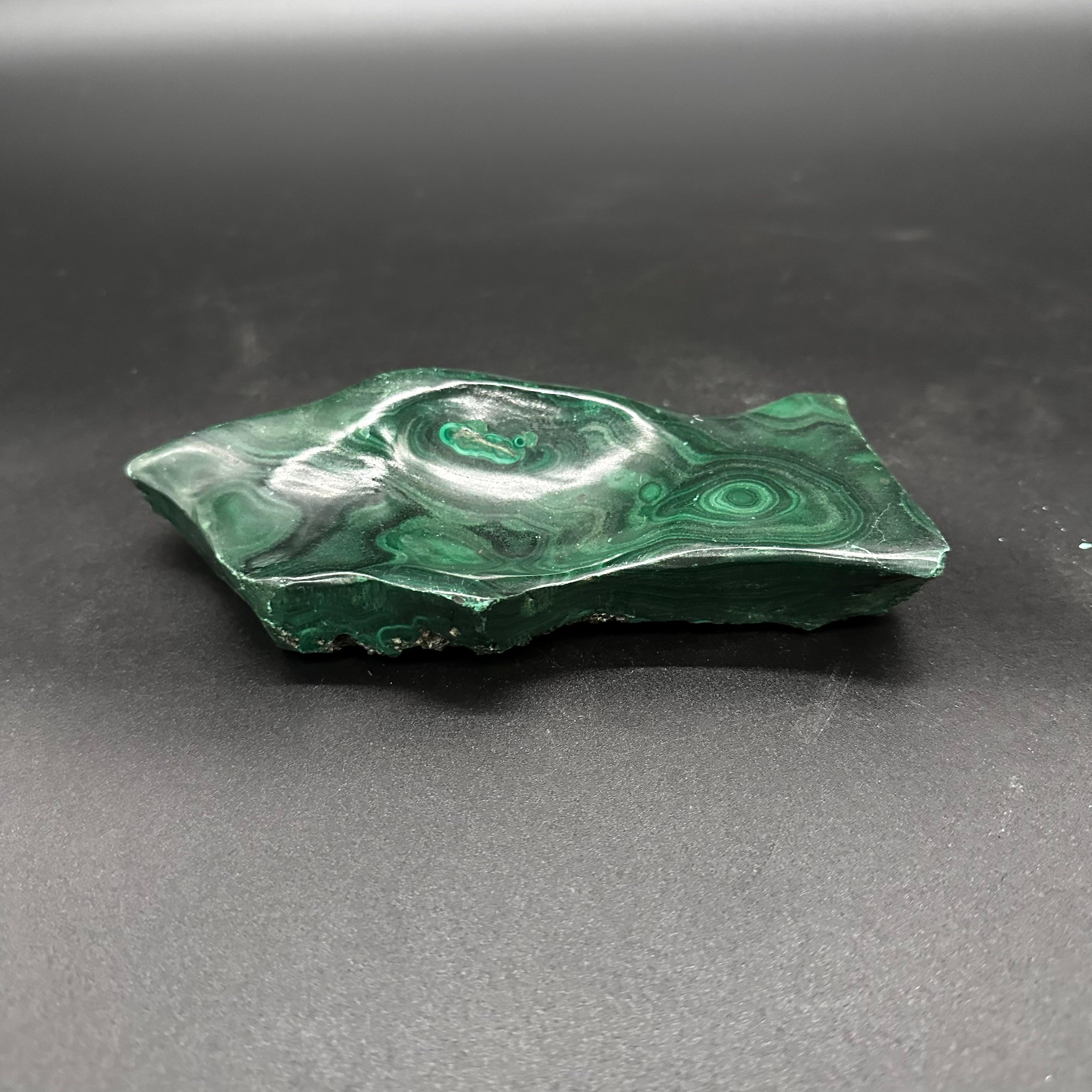 A vintage Italian Malachite ashtray from the 1960s is a small, elegant dish crafted from malachite stone in Italy during the 1960s, typically featuring rich green hues and a sleek design characteristic of the era.

