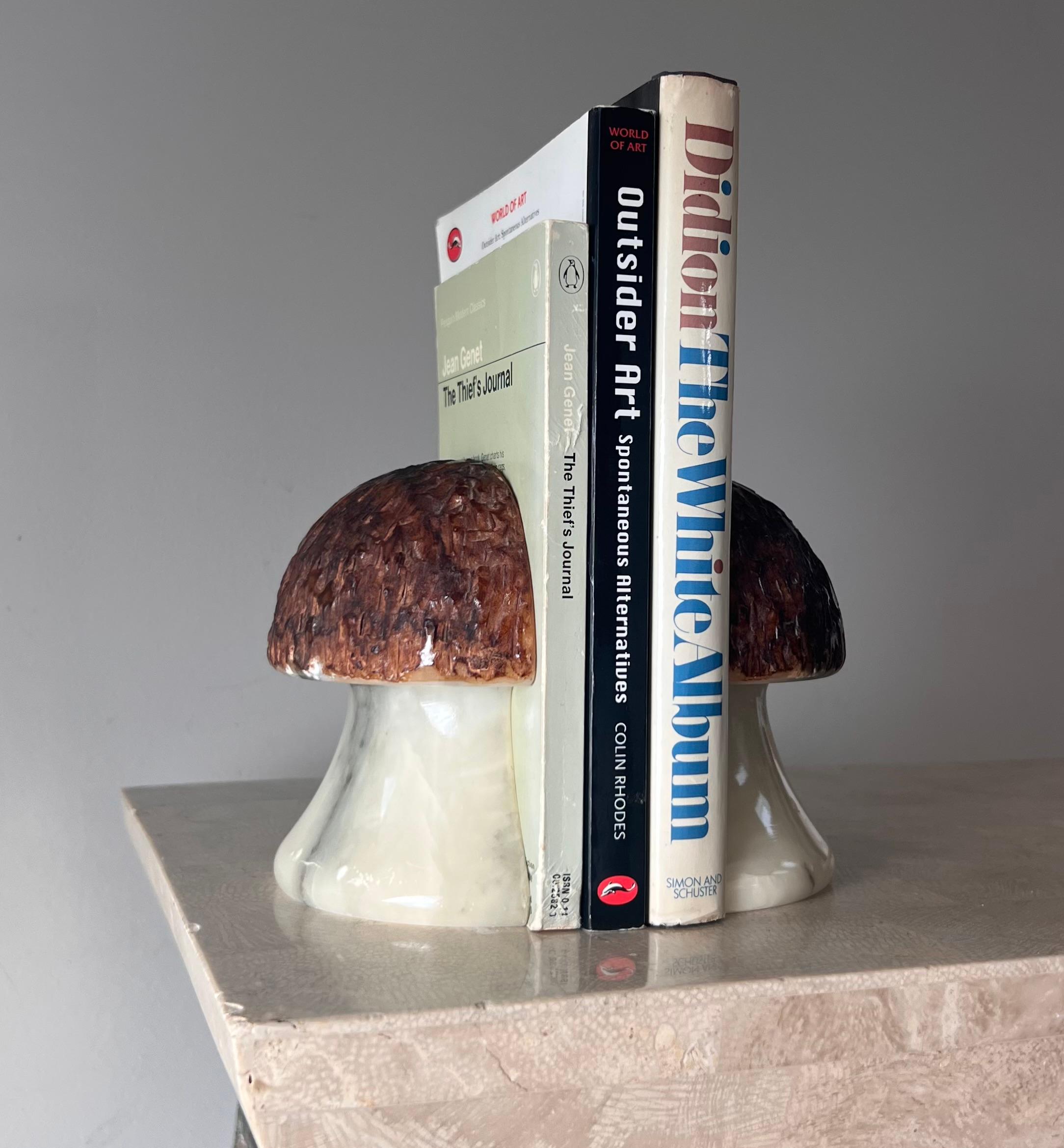 A pair of marble and alabaster mushroom bookends, hand-carved in Italy 1960s. Bases are eggshell with charcoal veining, while the caps are chestnut hued and textured. Some losses; please refer to photos. 
As a unit: 4.75” W x 4.5” D x 5” H
