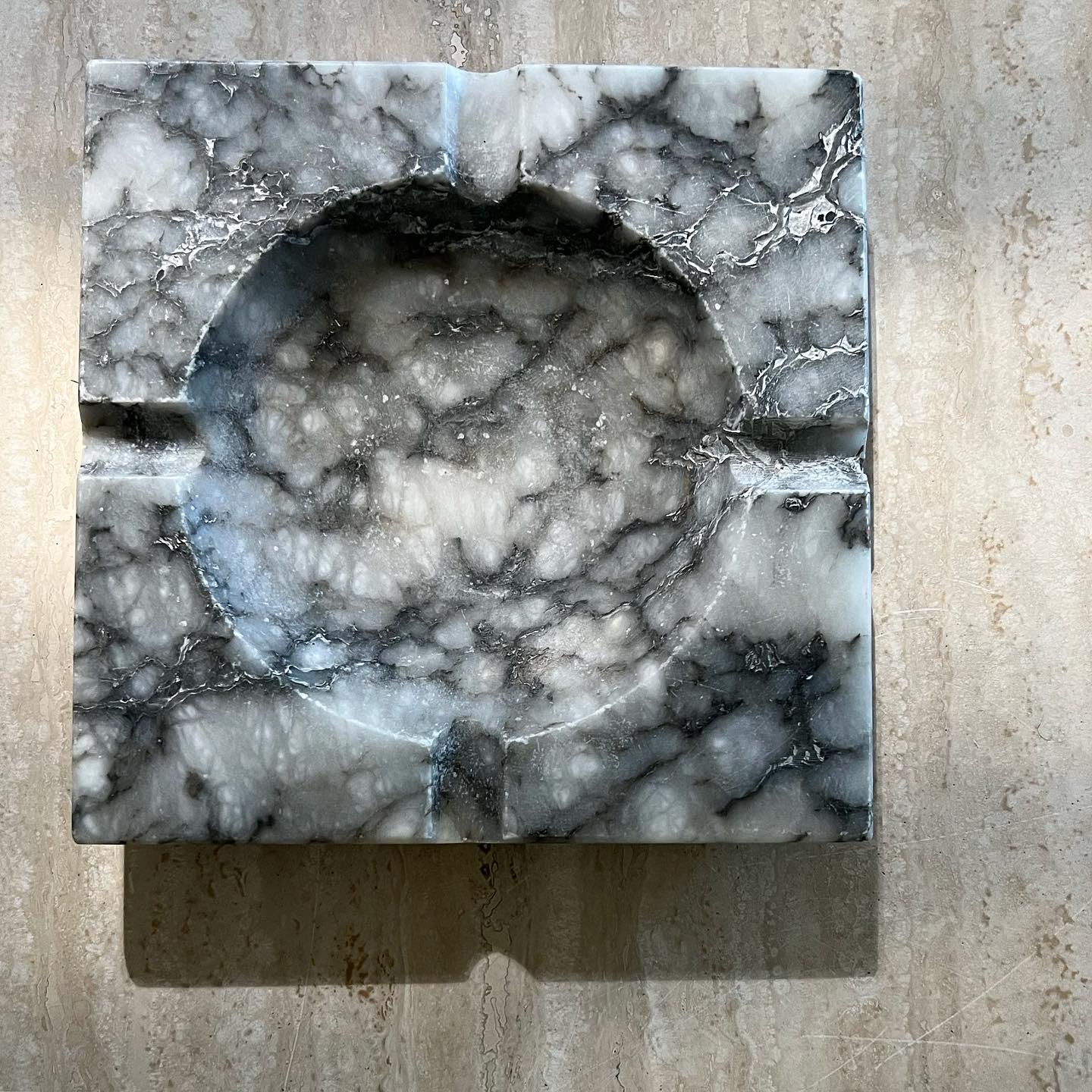 A large vintage Italian marble ashtray, 1960s. Tones of bone and charcoal and featuring a curved underbelly. Pick up in LA or worldwide shipping available.
Dimensions: 8” x 8” x 1.25”.