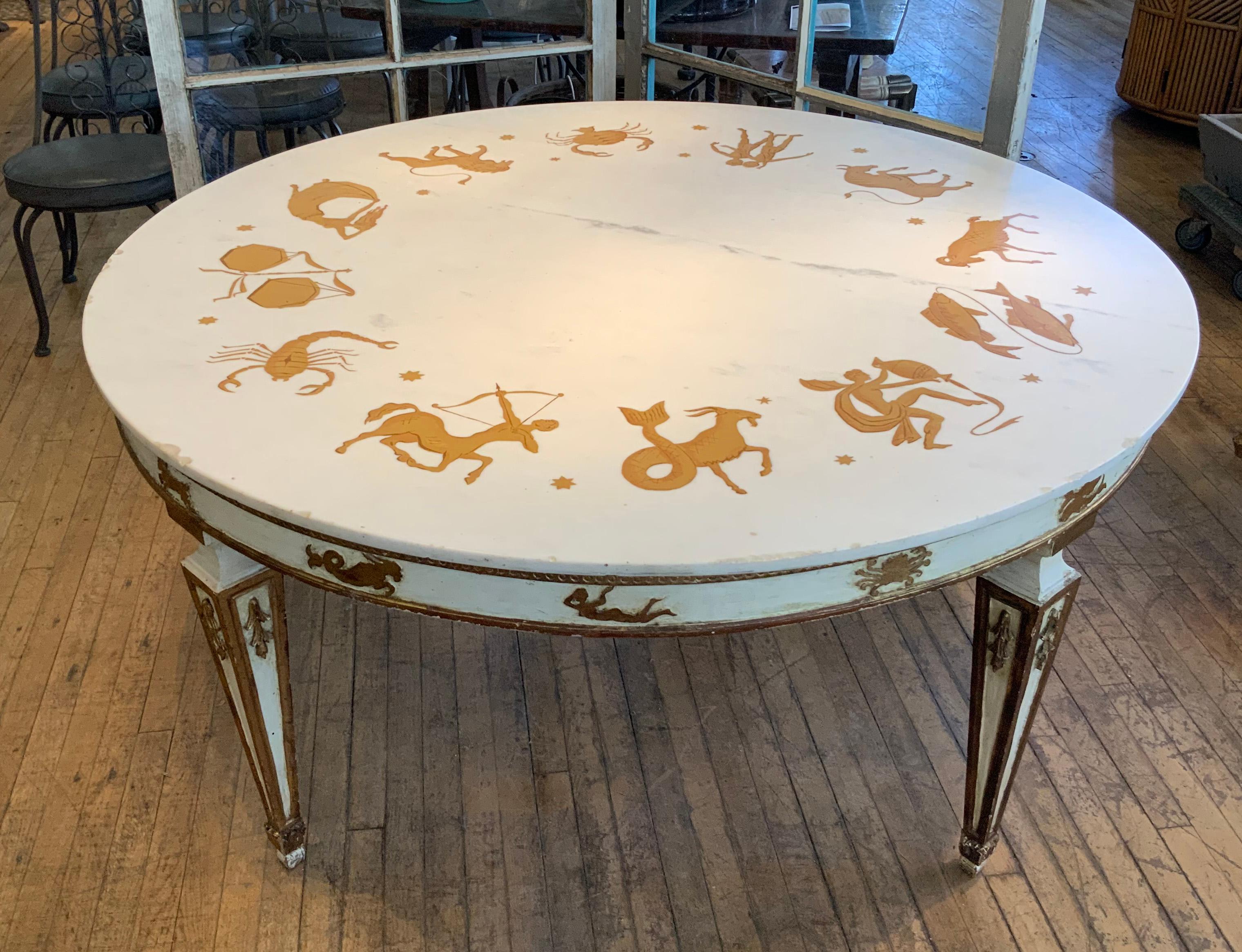 An incredible 1940's round marble top Italian dining table, with inlaid Zodiac signs all around, and the base carved and gilded with zodiac signs as well. retains its original label under the top. amazing table, incredibly unique. 

In good