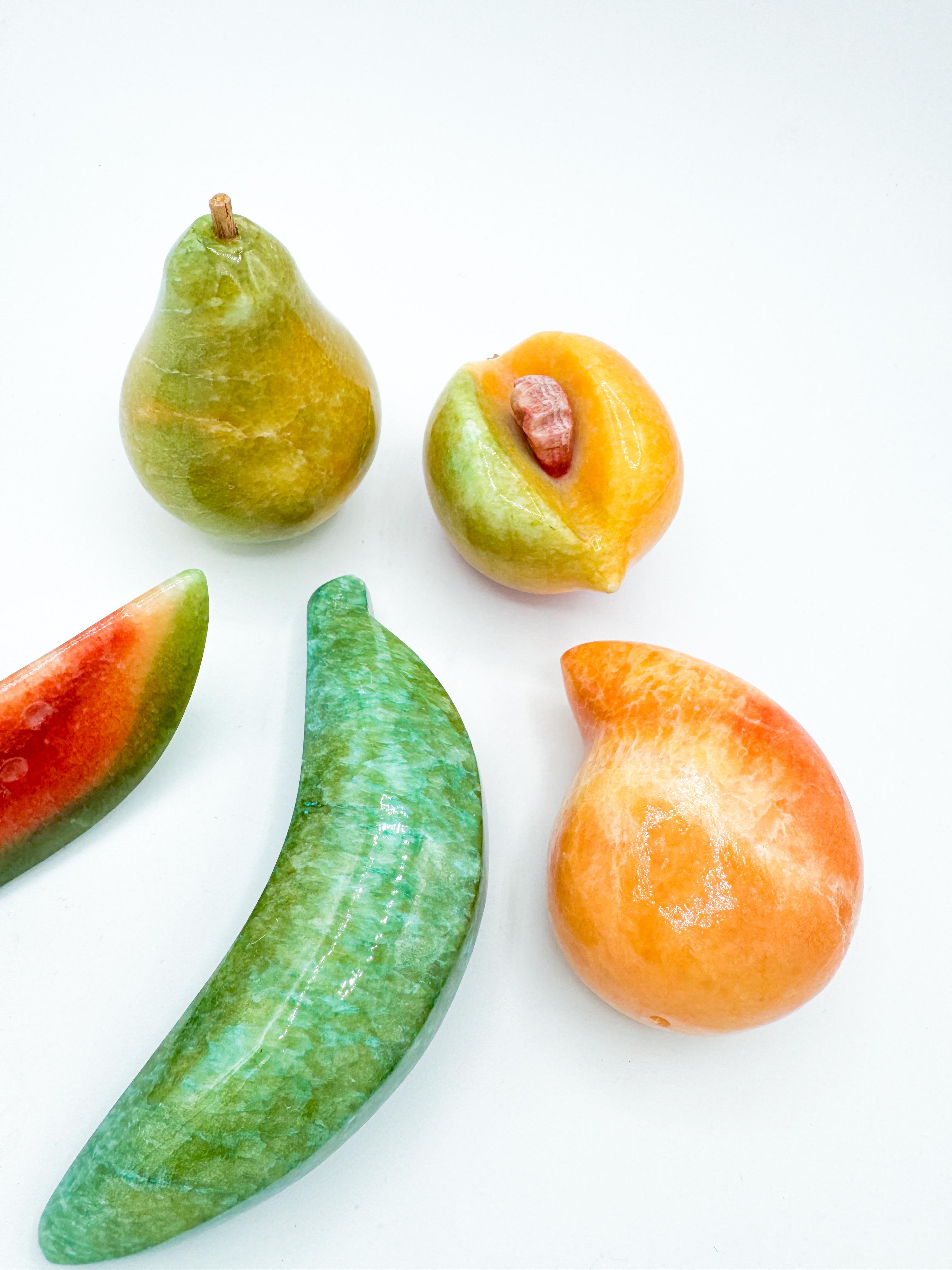 This charming set of five vintage marble fruits was handcrafted in Italy, showcasing the timeless artistry of stone carving. The collection includes a pear, banana, peach, mango, and a slice of watermelon—each piece meticulously sculpted from solid