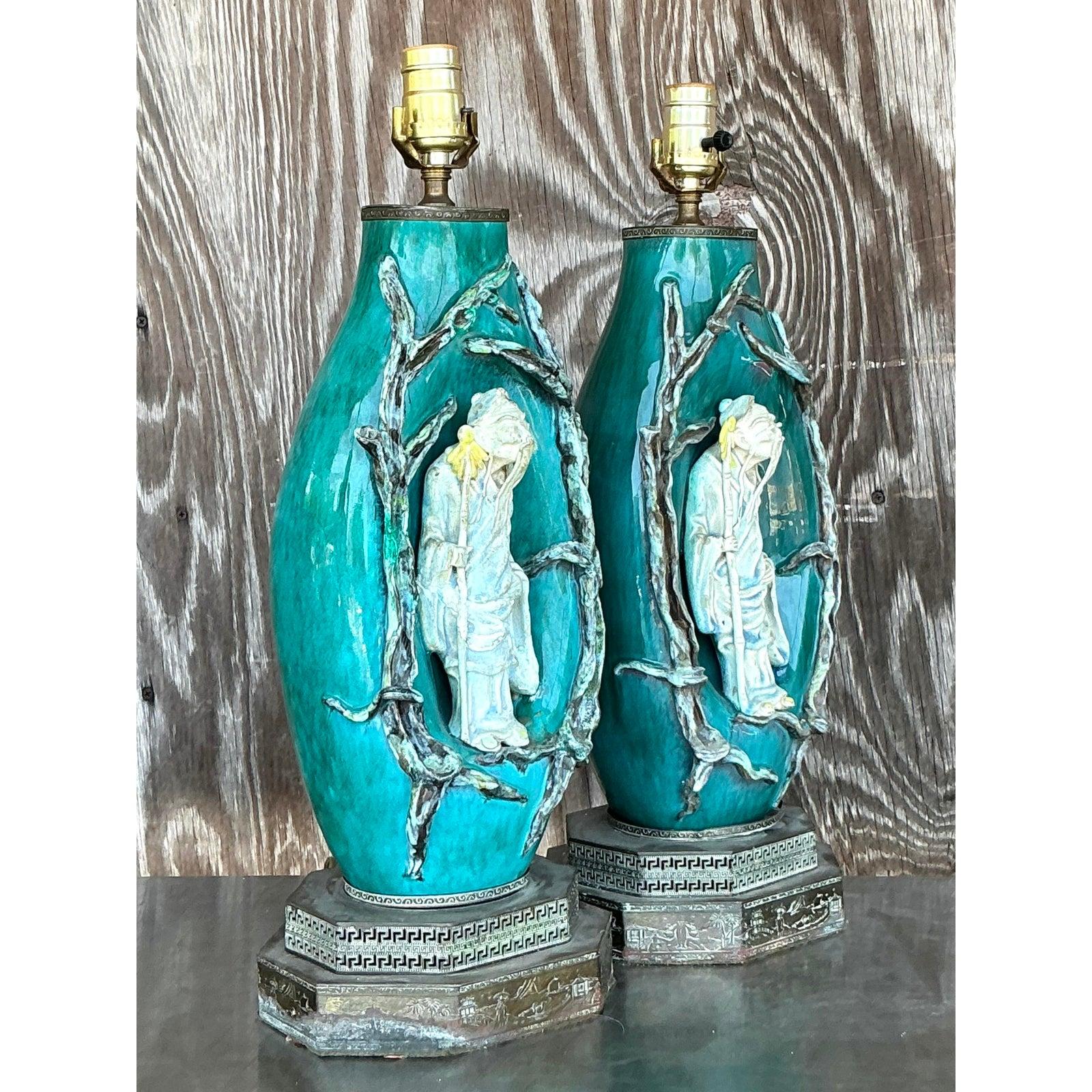 Elevate your interior with this exceptional pair of vintage Italian ceramic lamps, created by the renowned Marcello Fantoni. These exquisite lamps showcase Fantoni's distinctive artistic vision, featuring a captivating teal-blue glazed ceramic body