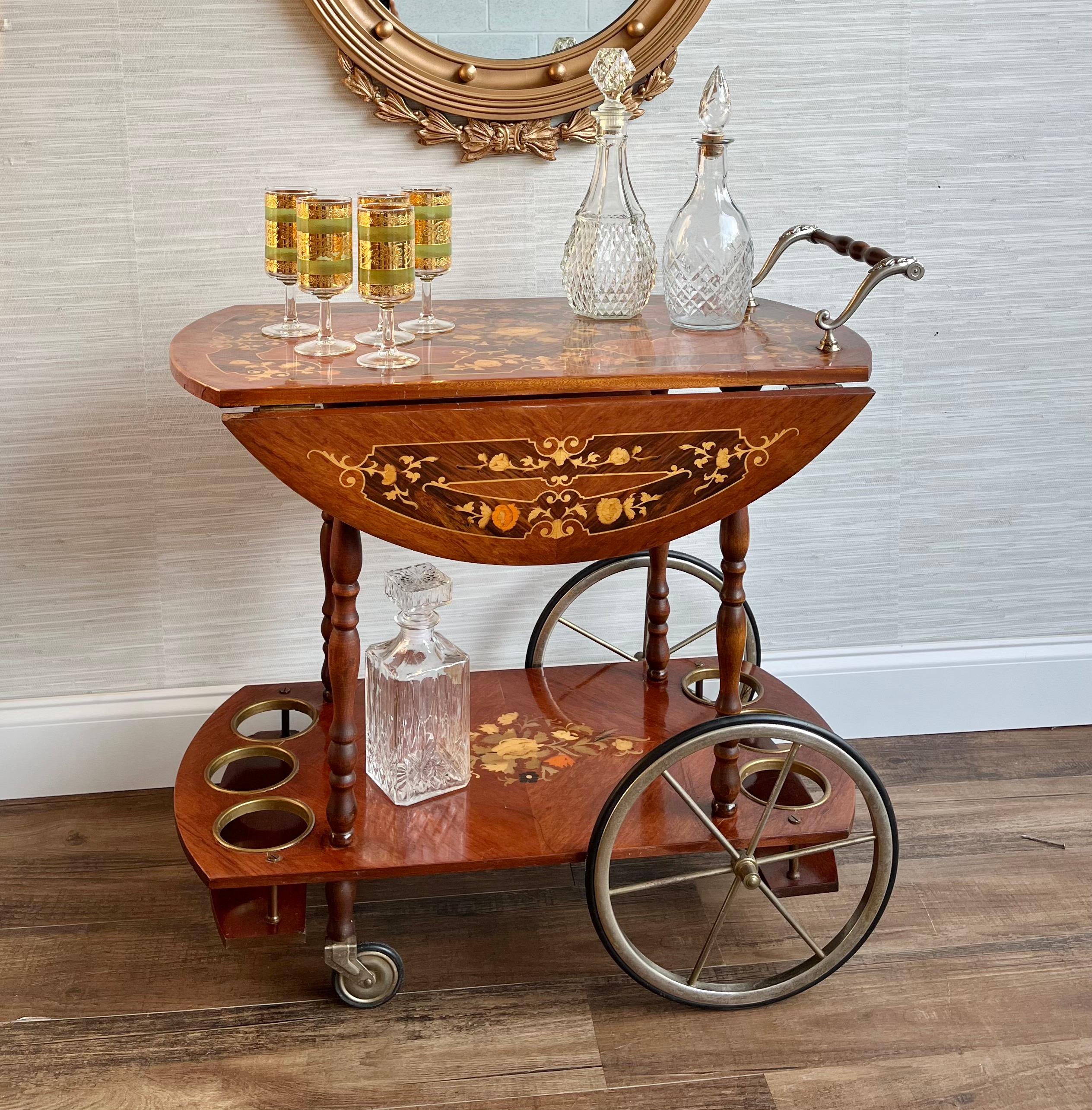 This Italian-style serving cart is a stunning piece of furniture that will add a touch of elegance to any room. The cart features beautiful inlaid wood marquetry that is expertly crafted and designed to impress. The cart is equipped with four