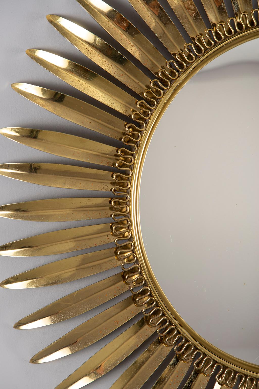 Gold tone metal framed sunburst mirror found in Italy, circa 1960s. Center mirror is convex. Minor scattered surface wear to metal frame.