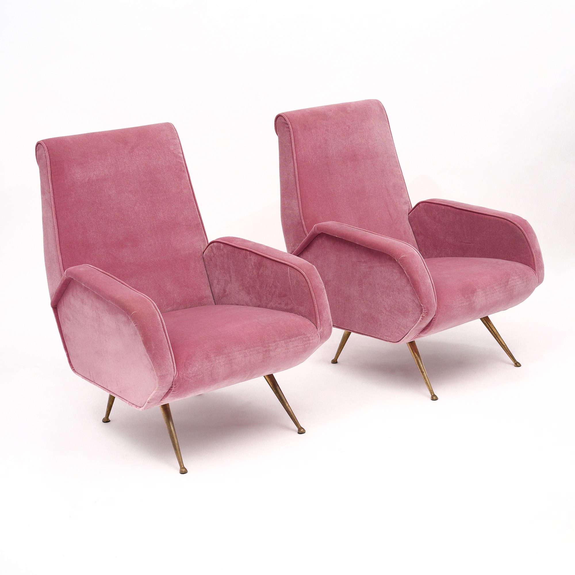 Pair of Italian vintage armchairs in the mid-century style that have been newly upholstered in a micro fiber velvet in a bright, warm pink tone. We love the iconic Italian brass legs that taper out for a subtle yet striking effect.
