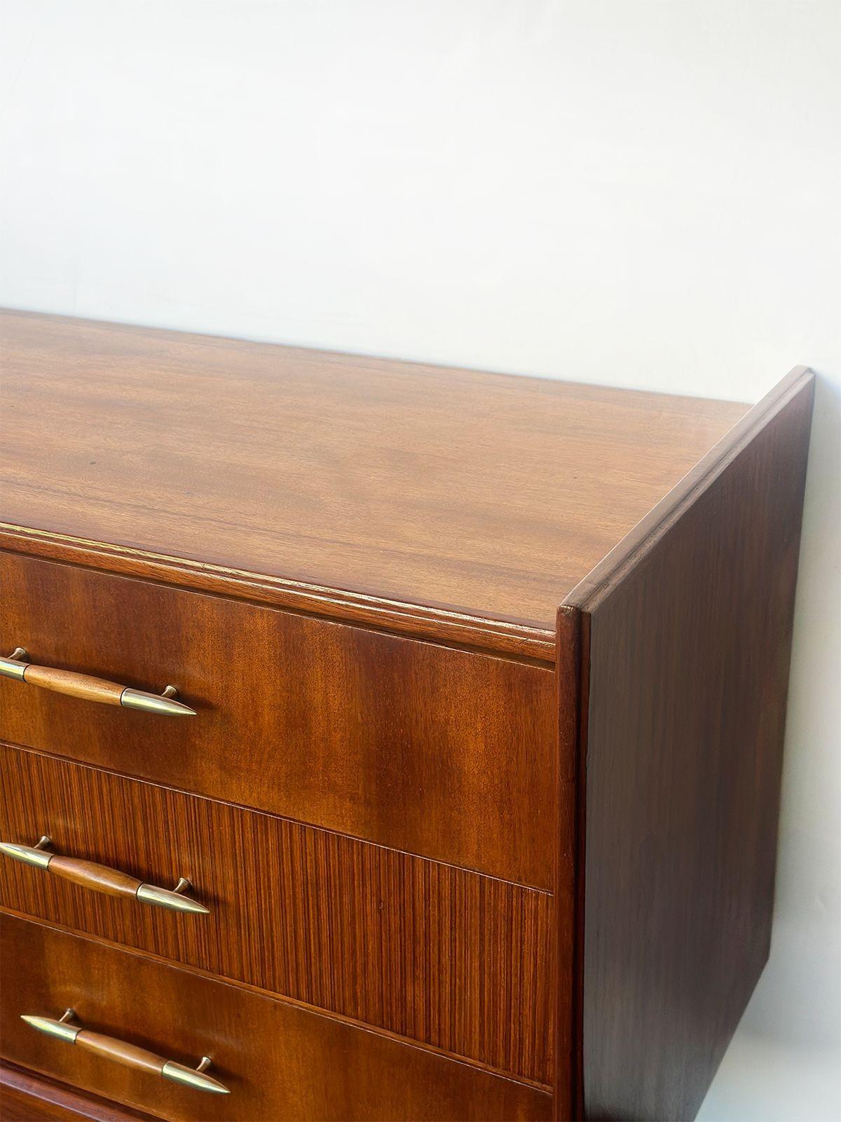 Vintage mid-century dresser made in Italy in the 1950s; made with rich wood and fine brass details which are integrated into the drawer handles and gracefully tapered legs.
The dresser offers ample storage space with its six spacious drawers. What
