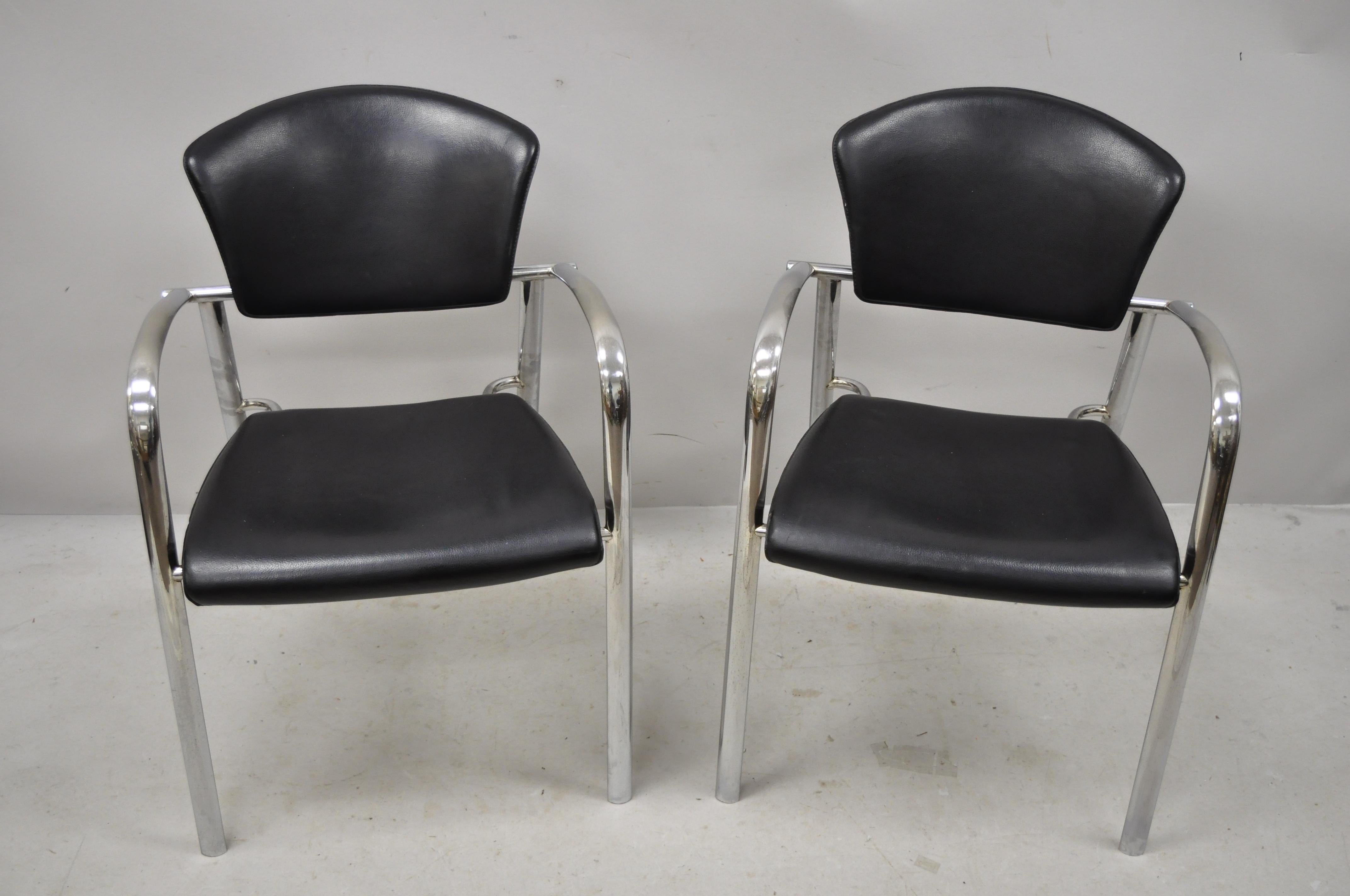 Vintage Italian Mid-Century Modern chrome sleek sculptural armchairs, a pair. Item features black stitched leather wrapped frames, chrome frames, very nice vintage item, quality Italian craftsmanship, sleek sculptural form, circa mid to late 20th