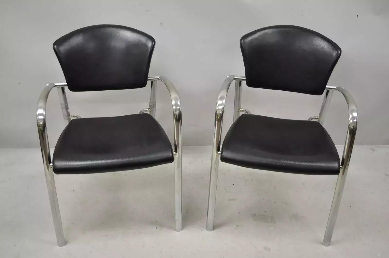 Vintage Italian Mid Century Modern Chrome Sleek Sculptural Arm Chairs - a Pair. Item features chrome and black stitched leather wrapped frames, quality Italian craftsmanship, sleek sculptural form. Circa Late 20th Century. Measurements: 31