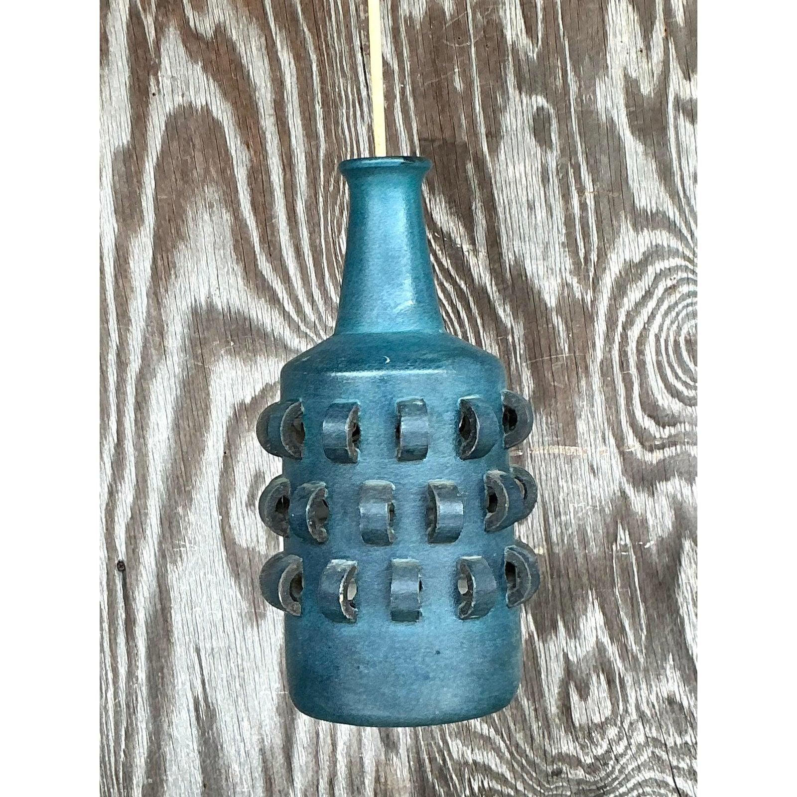 Elevate your space with this rare vintage Italian Mid-Century Modern ceramic hanging chandelier, a sculptural statement piece with undeniable retro flair. The hand-glazed matte blue finish evokes coastal Mediterranean serenity, while the bold looped