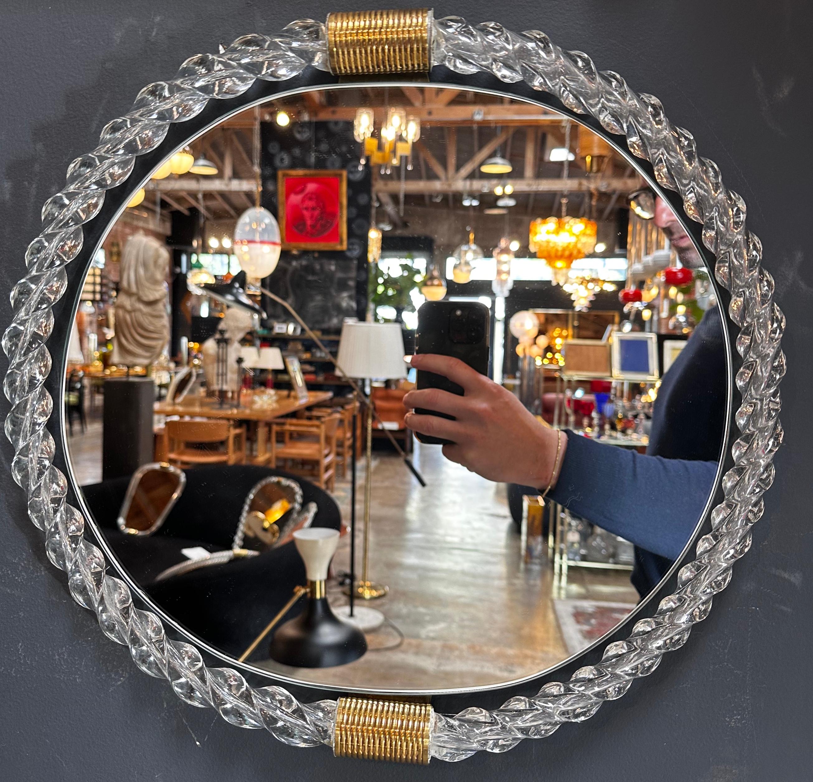 Elevate your space with our Vintage Italian Mid Century Murano Wall Mirror from the 1940s. This exquisite piece boasts a Murano twisted frame, showcasing the craftsmanship of the era. Brass details accentuate its elegance, creating a unique and