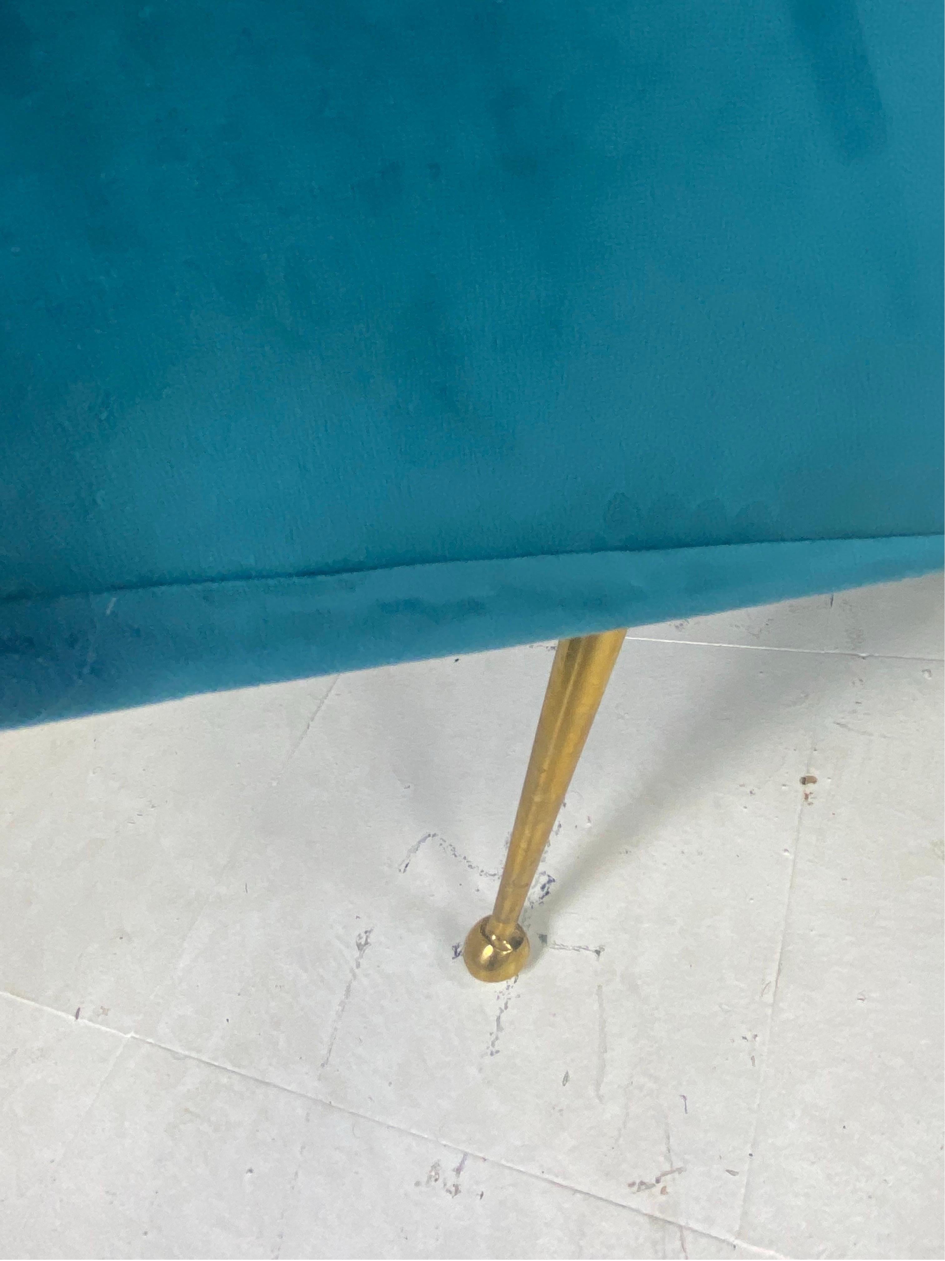 This is a pair of Italian vintage club chairs in the mid century style. These chairs are presented in a newly upholstered vibrant blue microfiber velvet. The chairs have a classic mid-century style leg in gold. These chairs were designed and made in