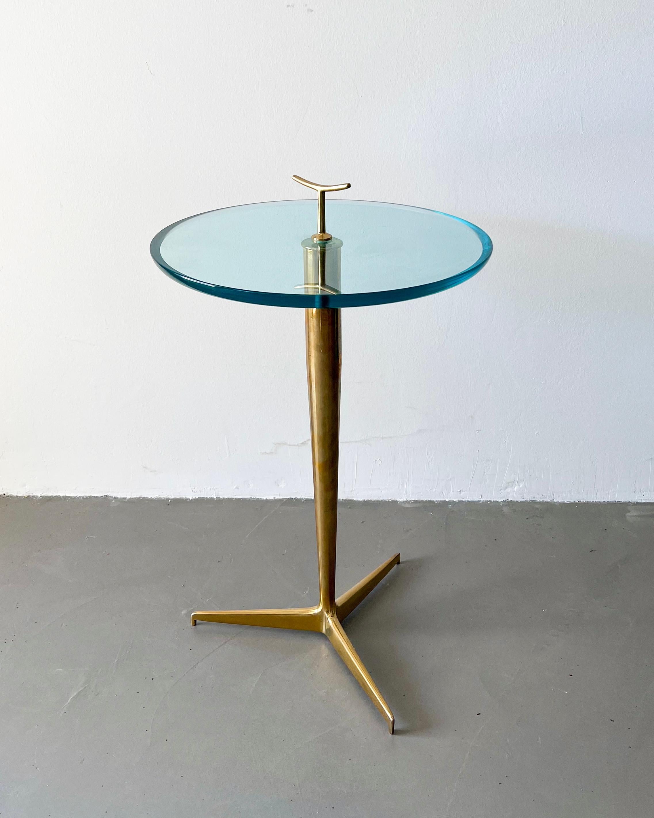 Vintage Italian midcentury side table in brass and glass by Giuseppe Ostuni.

The piece, preserved in stunning original condition, is a wonderful and sculptural side table by Italian designer Giuseppe Ostuni. The color of the glass top and the
