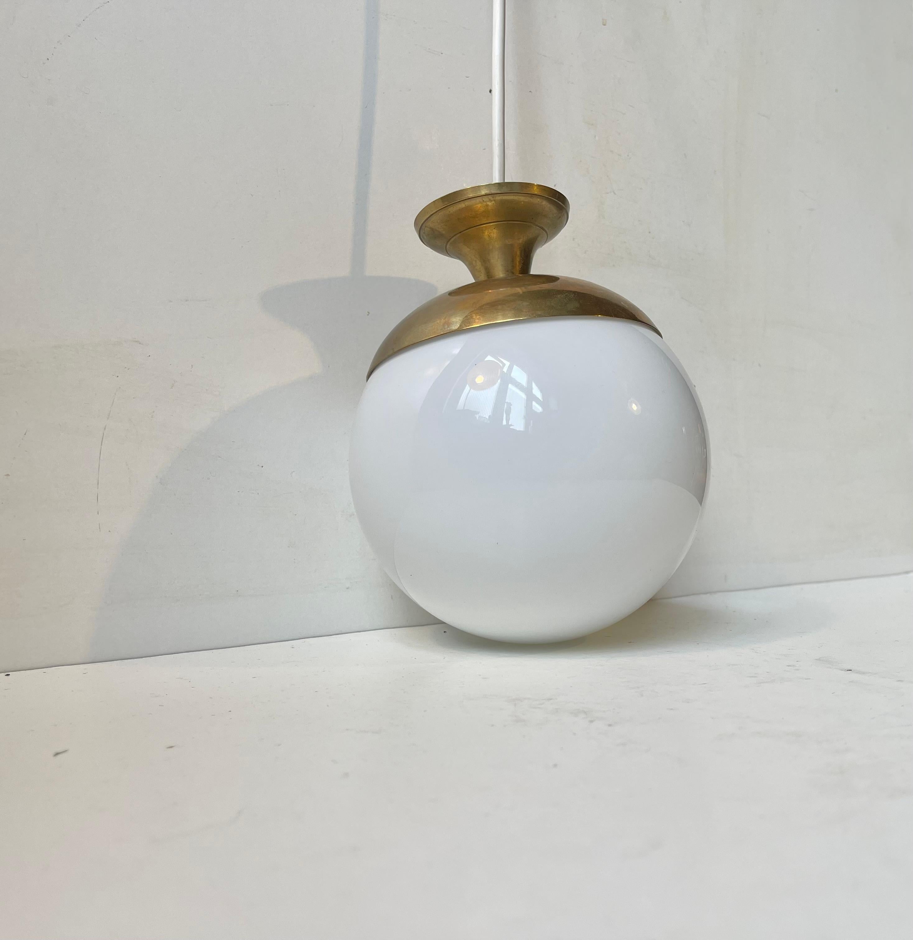 Small stylish hanging light featuring a diablo-shaped brass top and a spherical globe in white opal glass. It was manufactured in Italy during the 1960s. Measurements: H: 20 cm, Diameter: 15 cm. Working and tested vintage order. Comes installed with