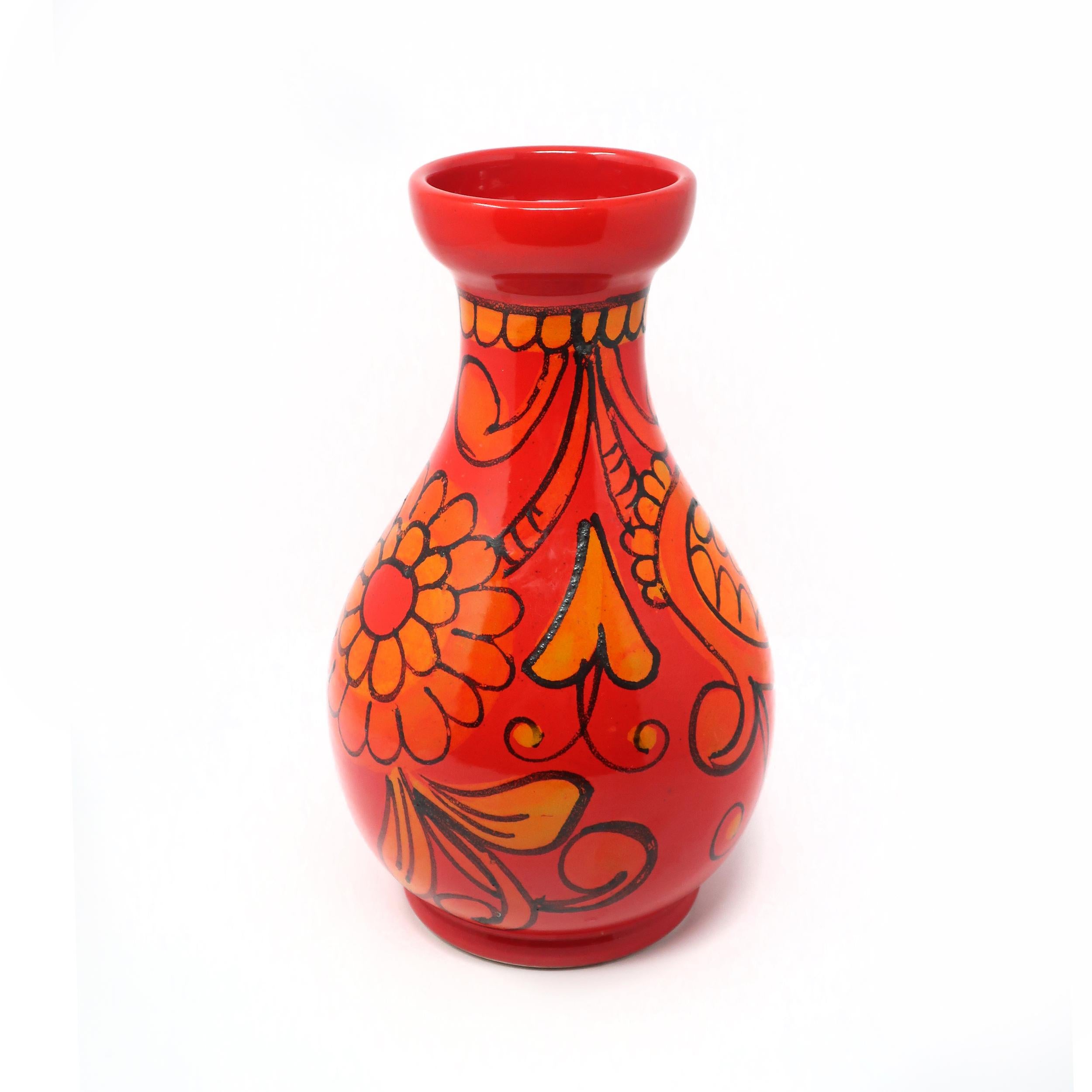 A mid-century modern Bitossi vase with red and orange glaze with raised accents of plants and flowers. 

Glaze is bright and in good vintage condition with wear consistent with age and use. Marked “X158/A Italy” on underside.

Measures: 7