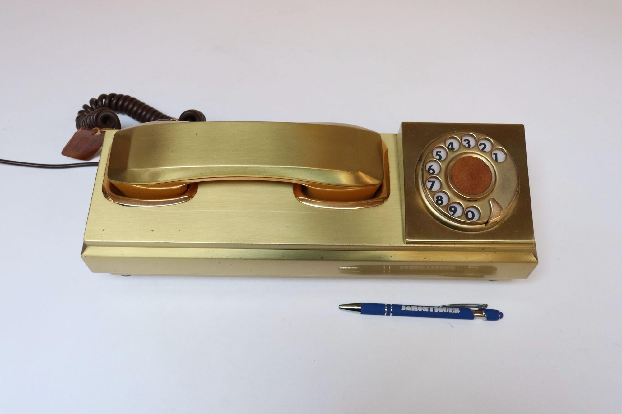Rotary telephone in gold anodized aluminum by CR Telefonia (ca. 1970s, Italy).
Handset is composed of an aluminum exterior and plastic interior and dial features a leather center.
Never used, original condition retaining the original leather