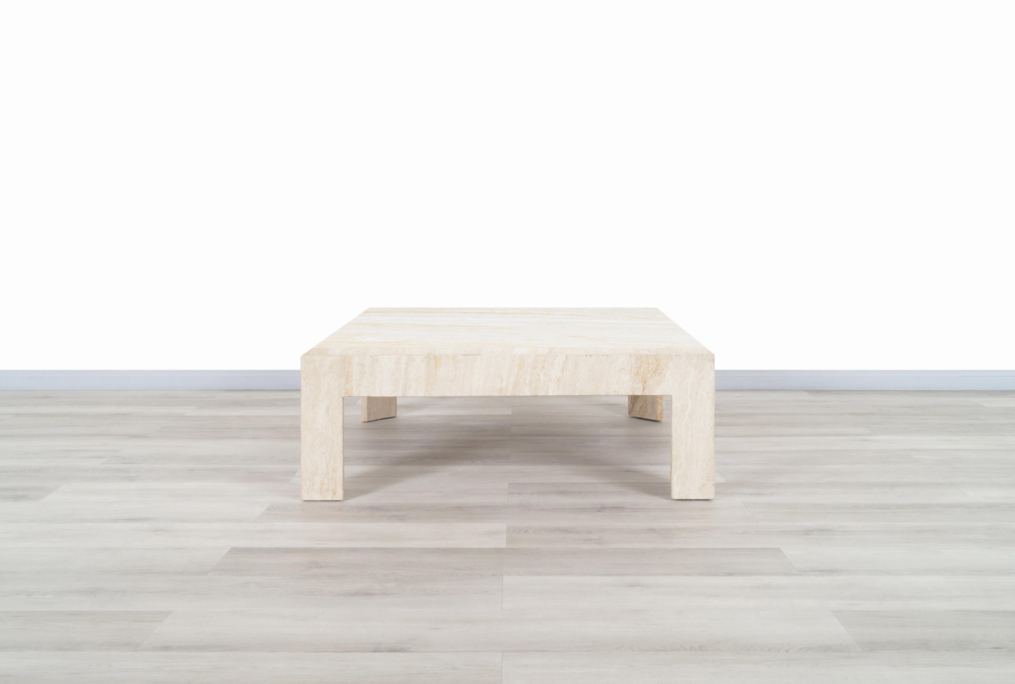 A stunning vintage travertine coffee table designed and manufactured in Italy. The modernist design is perfectly complemented by the natural minerals that creates the travertine stone. The table features a beautiful travertine top with Minimalist