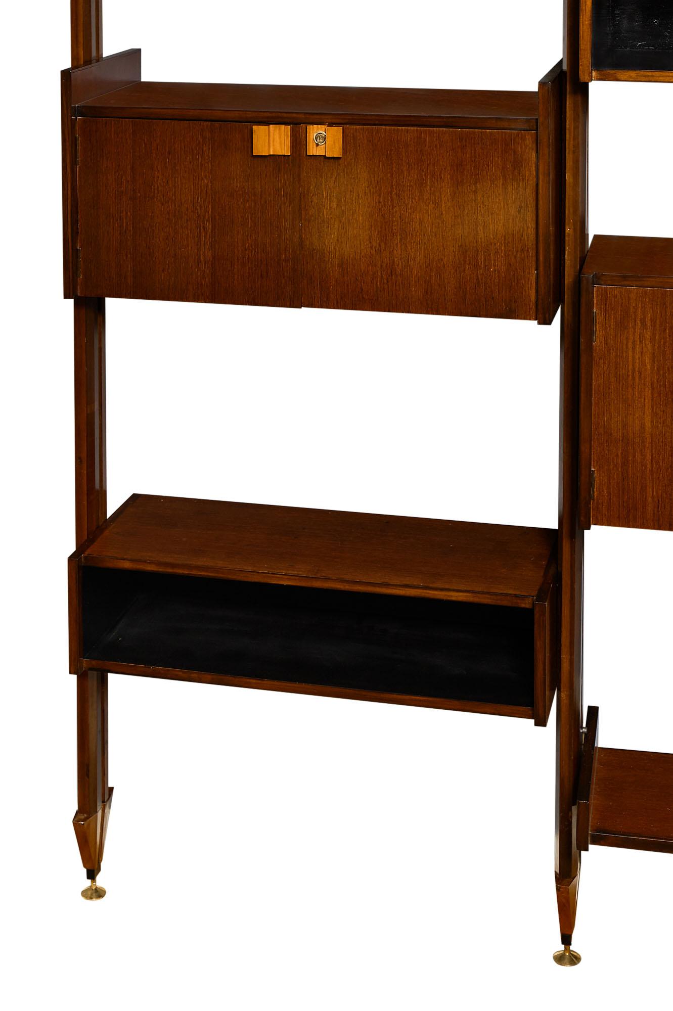Vintage modular Italian bookcase from the 1950s. This important cabinet features various elements of Brazilian rosewood adorned with maple handles. The opened drawers; modular shelves; and cabinets with doors can be arranged as desired. This