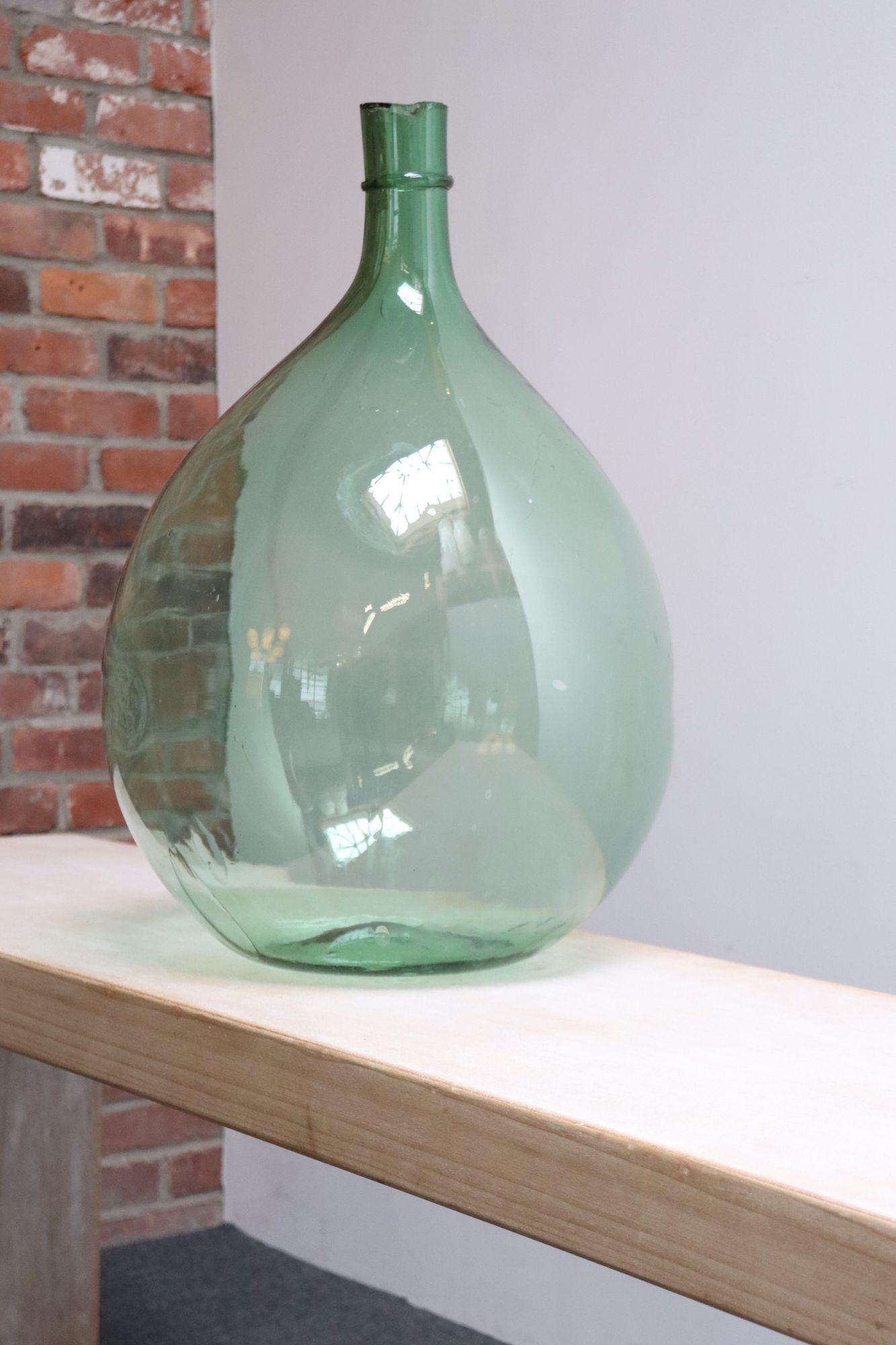 Italian Demijohn / Carboy originally used for transporting wine (ca. early 20th Century, Italy).
Composed of attractive pale green/light seafoam free-blown glass exhibiting trapped air bubbles within the glass itself with a sheared lip and applied