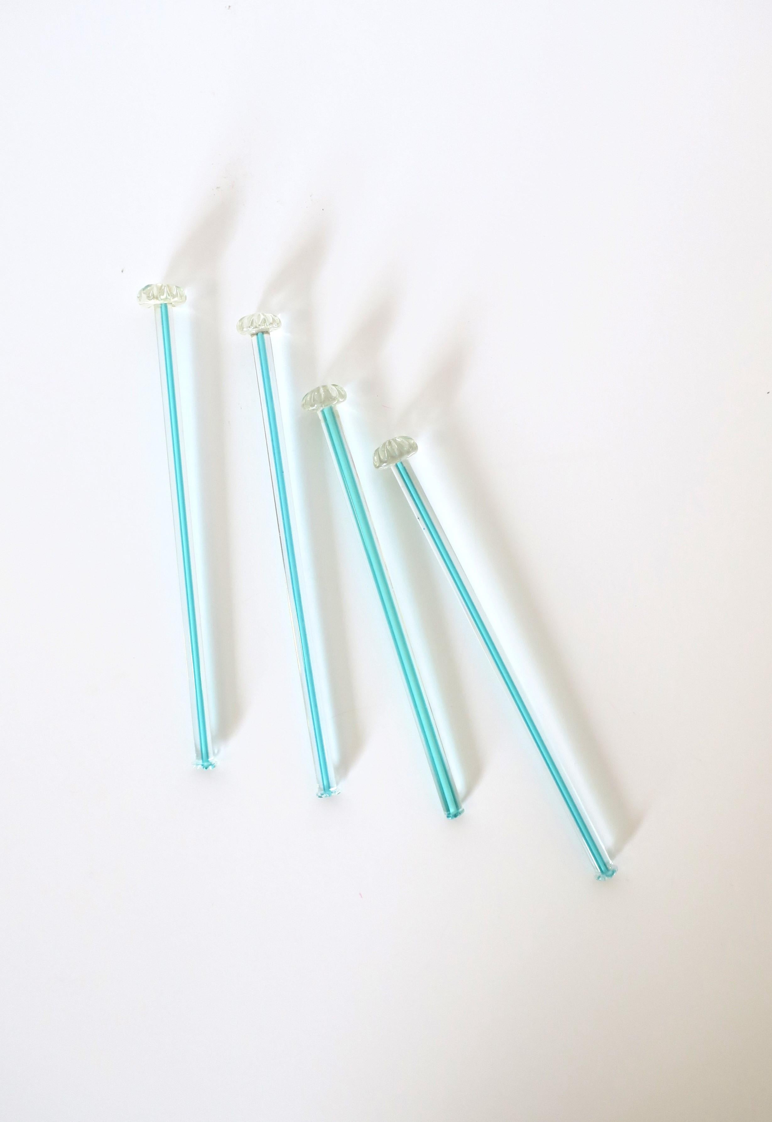 A very beautiful and rare set of four (4) vintage hand crafted Italian Murano barware art glass cocktail stirrers, circa Mid-20th Century, Italy. Set is both transparent / clear and turquoise blue art glass with floweret top and scored bottom.
