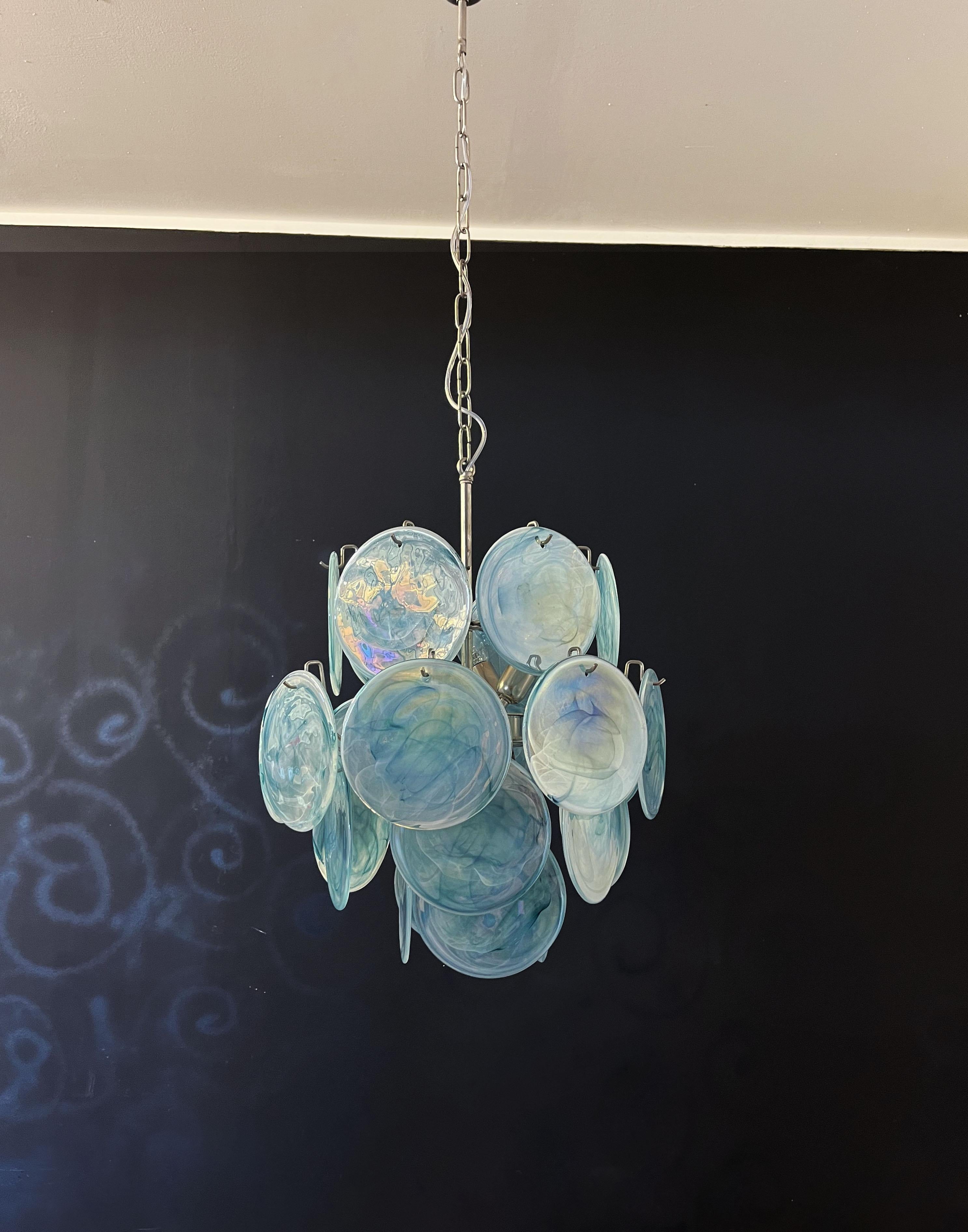 
Vintage Italian Murano chandelier in Vistosi style. The chandelier has 24 fantastic iridescent alabaster boue discs in a nickel metal frame.
Period: late XX century
Dimensions: 41,30 inches (105 cm) height with chain; 20,50 inches (52 cm) height