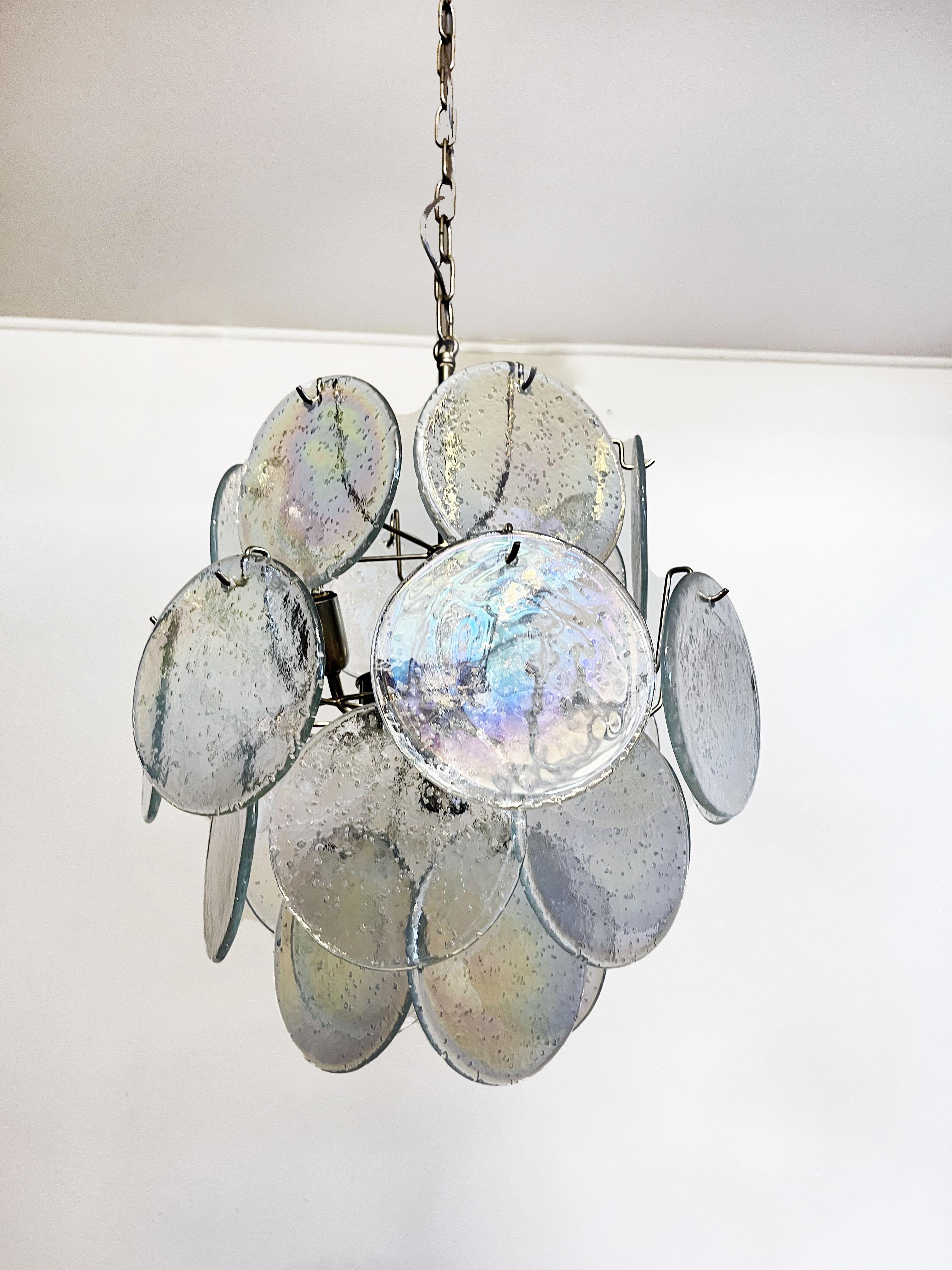 Vintage Italian Murano chandelier in Vistosi style. The chandelier has 24 fantastic iridescent grit discs in a nickel metal frame. The glasses have the particularity of reflecting a multiplicity of colors, which makes the chandelier a true work of