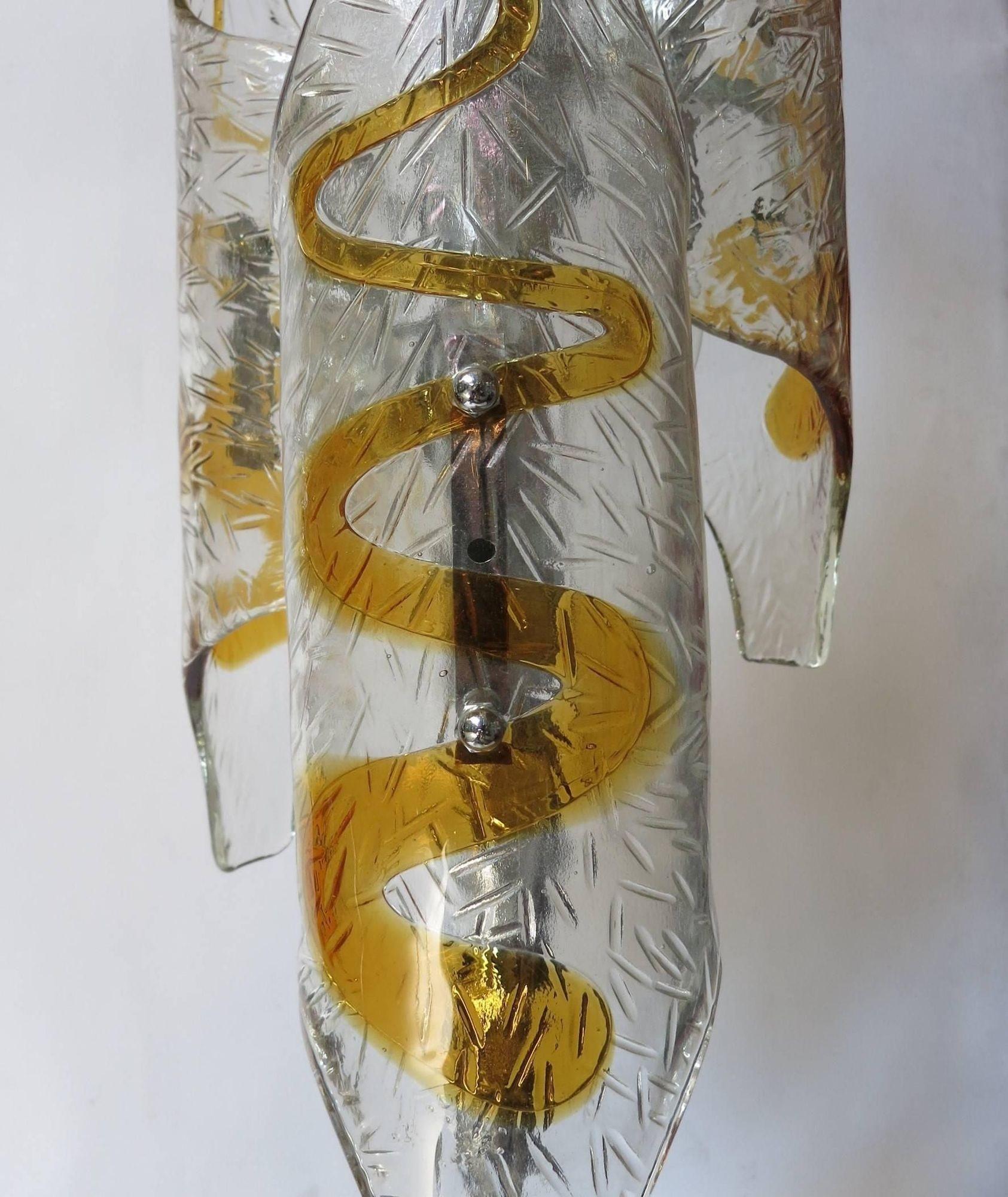 Stunning vintage Italian floor lamp designed by Mazzega in the 1970s, featuring three hand-blown tubular Murano glass shades in clear and amber hues. Each glass element showcases exquisite craftsmanship, mounted on a sleek chrome frame. This