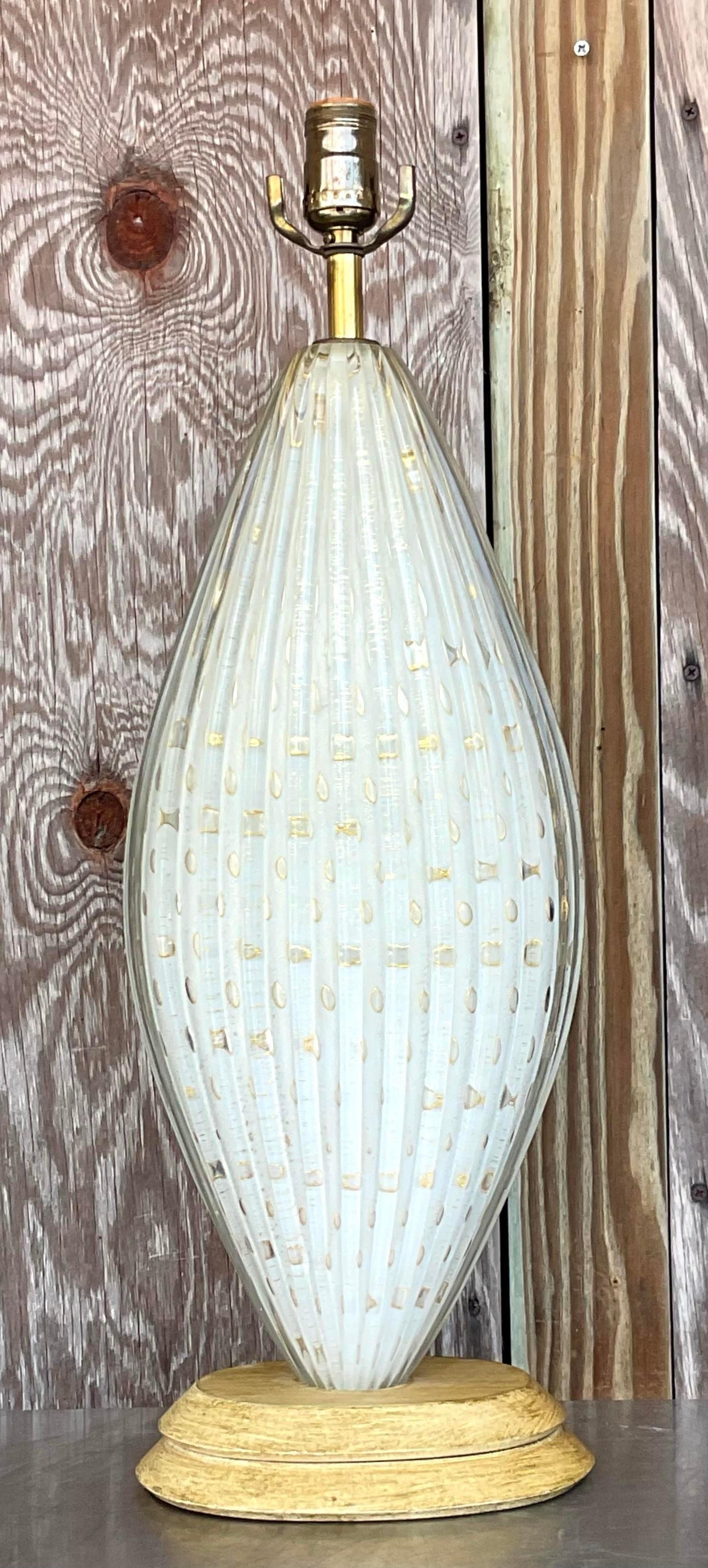 Illuminate your space with the timeless elegance of this Vintage Italian Murano Glass Lamp. Handcrafted with exquisite detail, its vibrant colors and intricate design bring a touch of classic Italian artistry to your American home. Ideal for adding