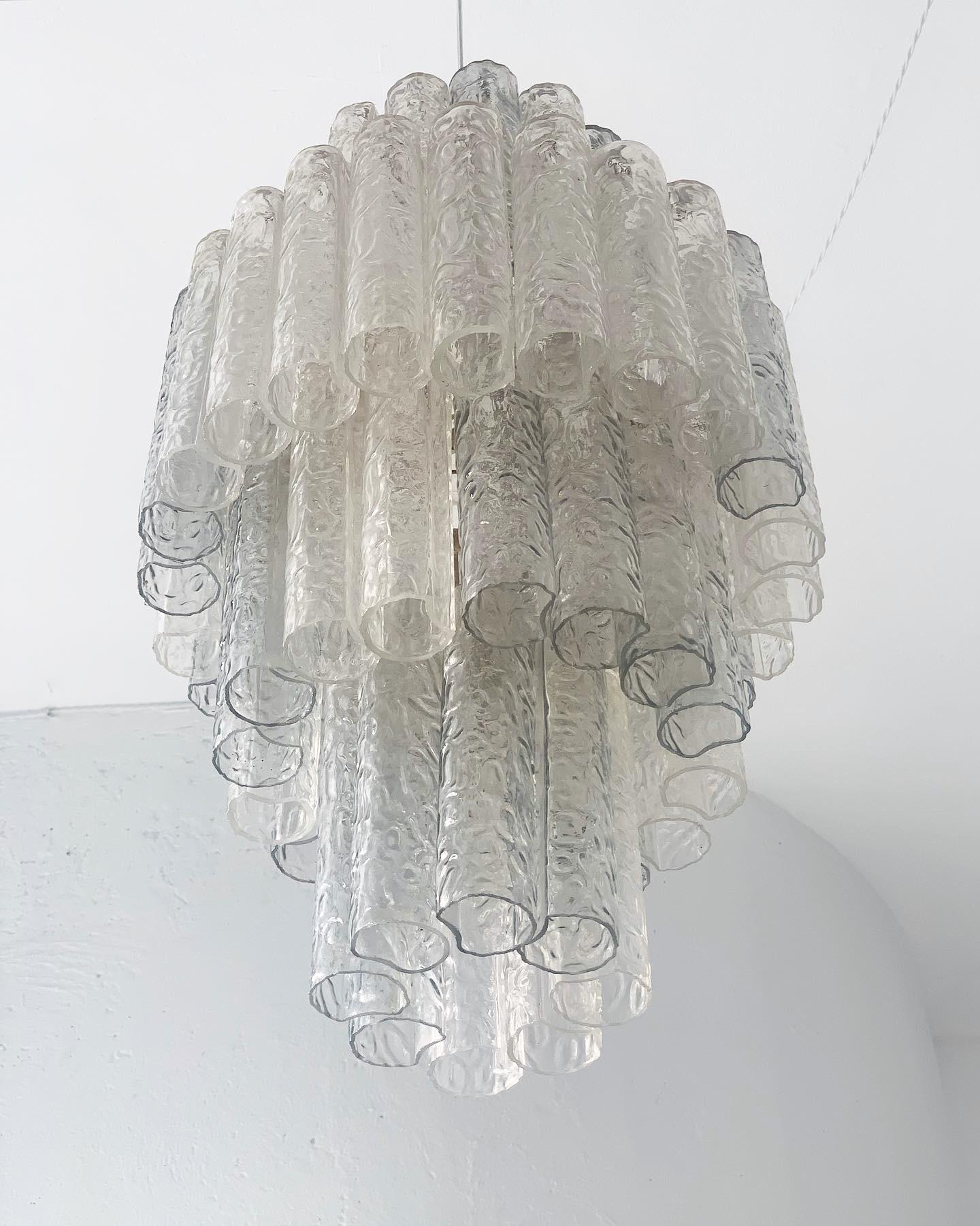 Offered for sale is a big and scenic chandelier in Murano glass, made (obviously) in Italy at the beginning of the 1960s. While the frame and glass pipes are not signed, it is clearly made in the style of Toni Zuccheri and Venini, two of the